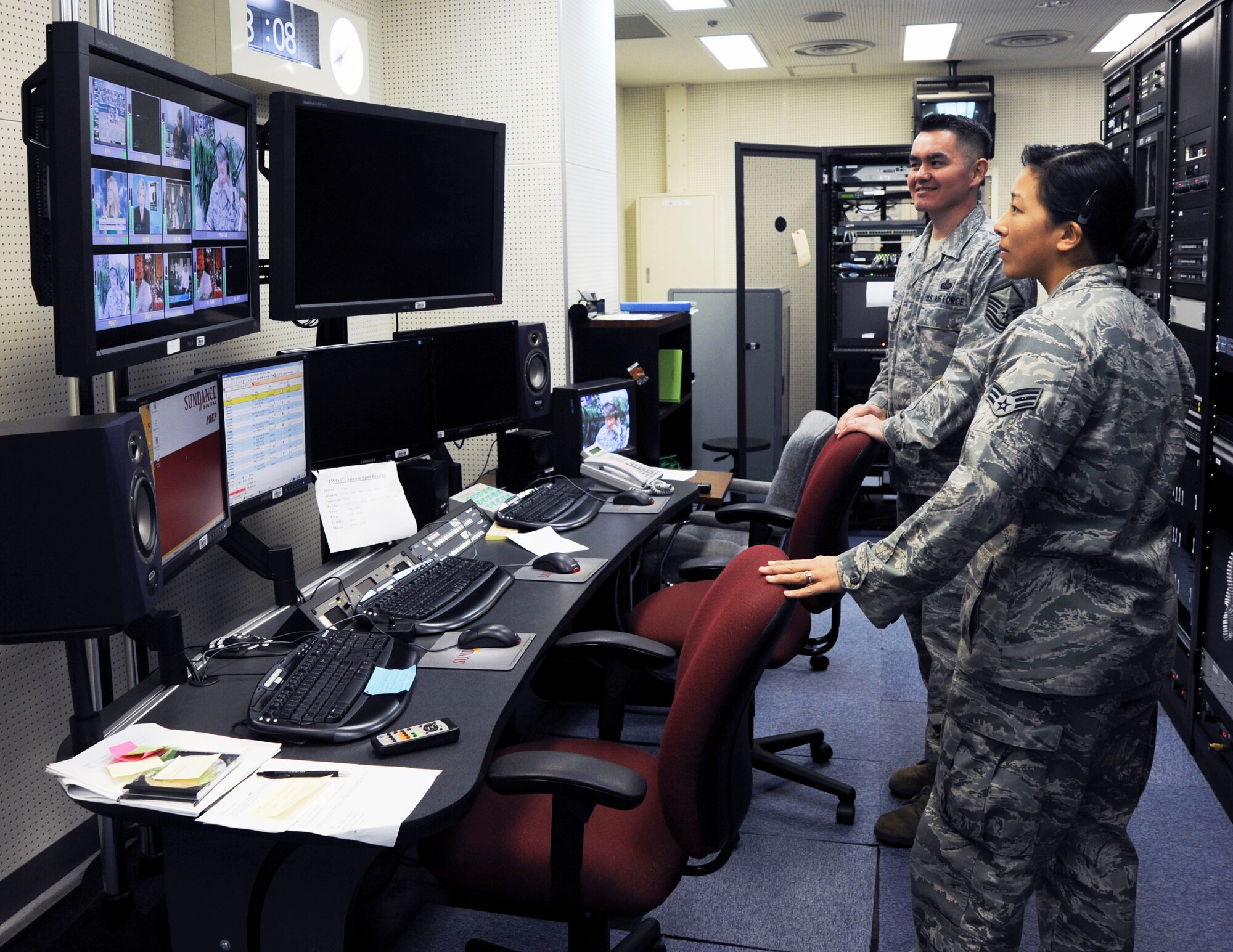 U.S. Air Force Senior Airman Melissa Campbell, right, American Forces Network Misawa, Master Sgt. James Craig, back, monitor the Commander's Open Line radio show in the control room at Misawa Air Base, Japan, Oct. 29, 2010. AFN, a tenant unit of the Misawa Air Base provides news and information to the community via radio and television. (U.S. Air Force photo by Tech. Sgt. Russell McBride/ Released)