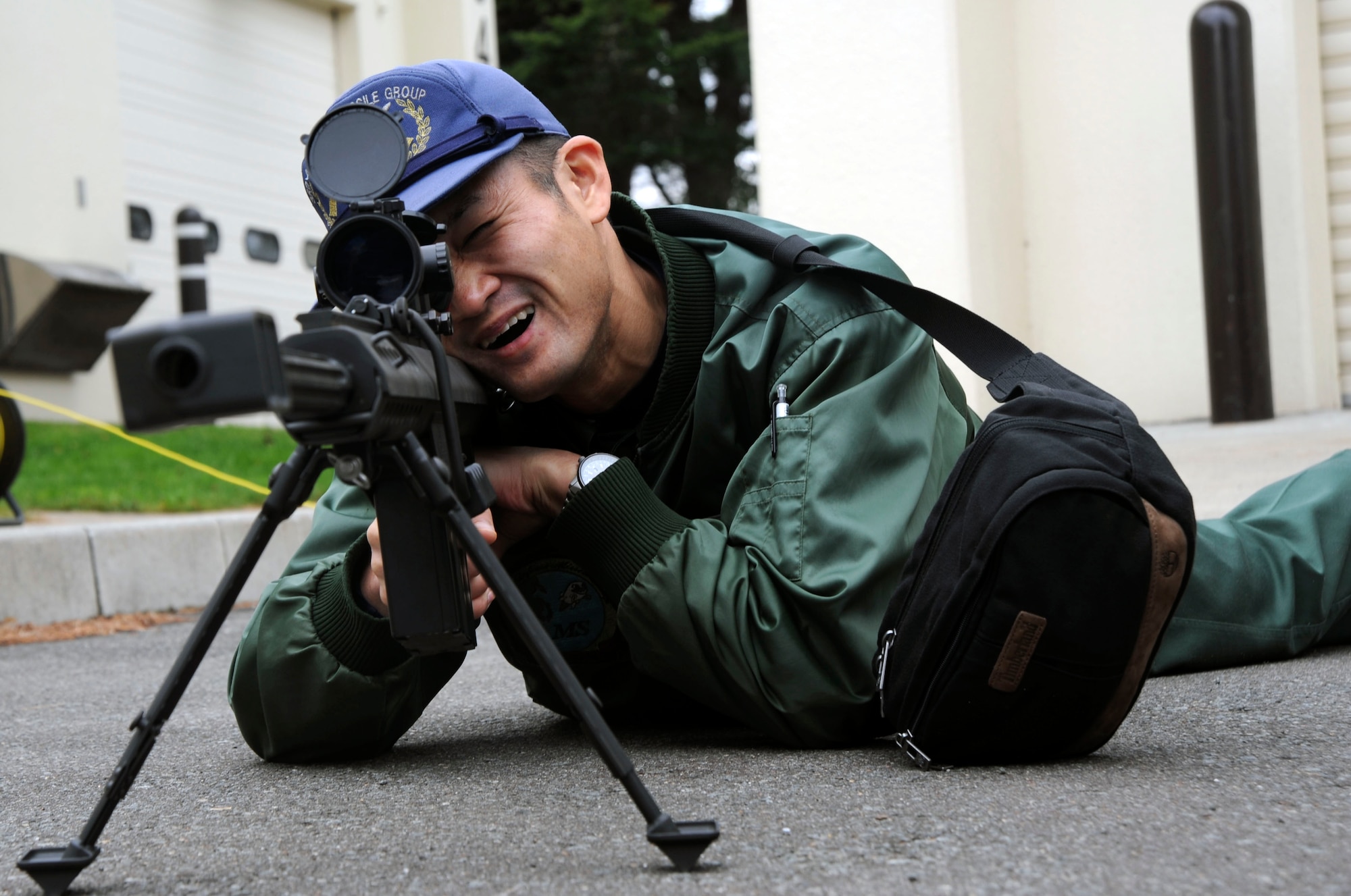 Staff Sgt. Yuuji Yamashita, Chitose Japan Air Self-Defense Force, looks through a scope attached to a Barrett M-107 rifle at Misawa Air Base, Japan, Oct. 27, 2010.  The M-107 is a rugged, dependable semi-automatic weapon used by military units like EOD. (U.S. Air Force photo by Tech. Sgt. Russell McBride/Released)