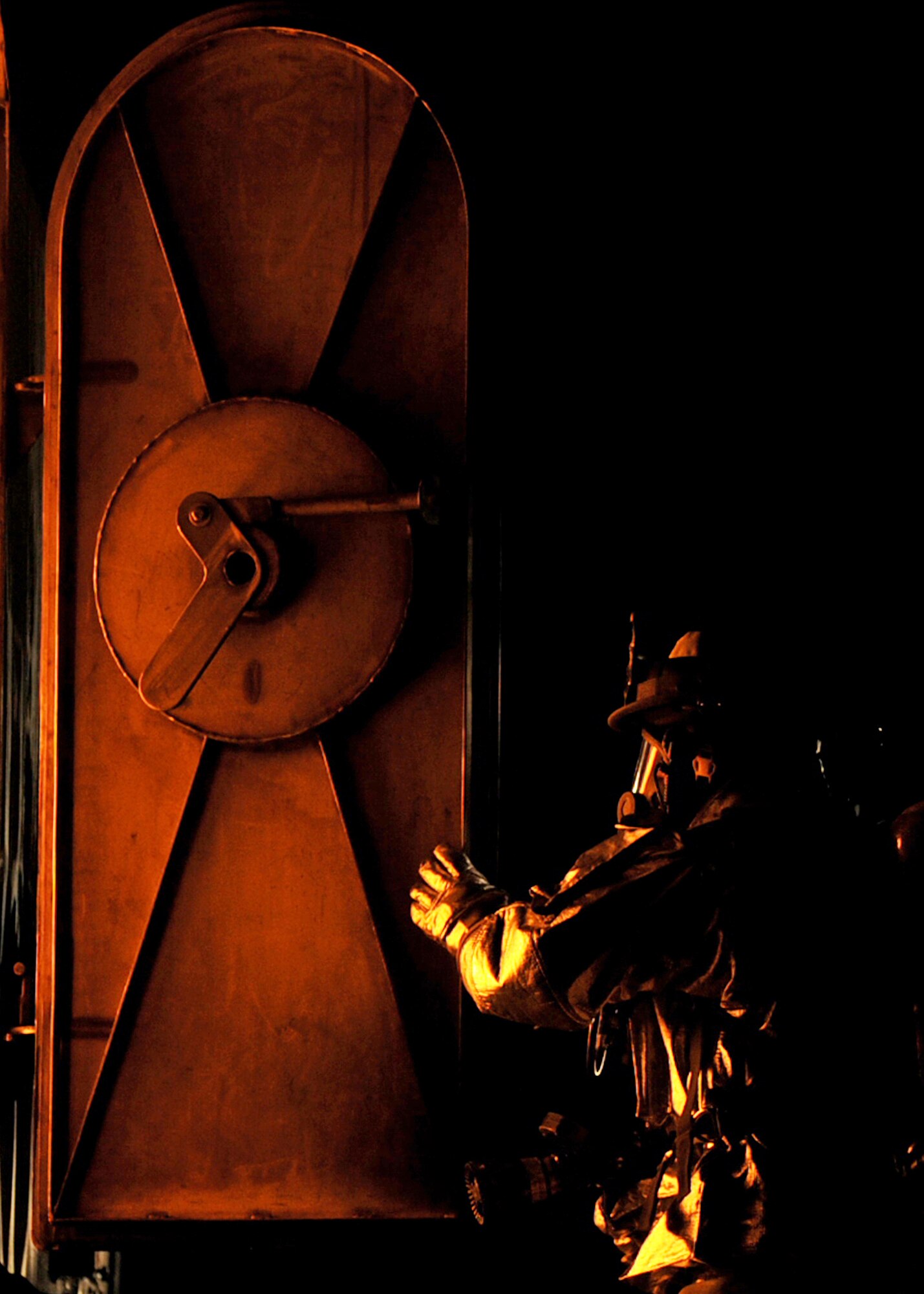SOUTHWEST ASIA -- A firefighter from the 386th Expeditionary Civil Engineer Squadron prepares to enter a simulated aircraft to extract personnel during rescue operations as part of live-fire training Oct. 27 at a U.S. military installation here. The fire team consists of Airmen from five different Air National Guard units. (U.S. Air Force photo by Senior Airman Laura Turner) 