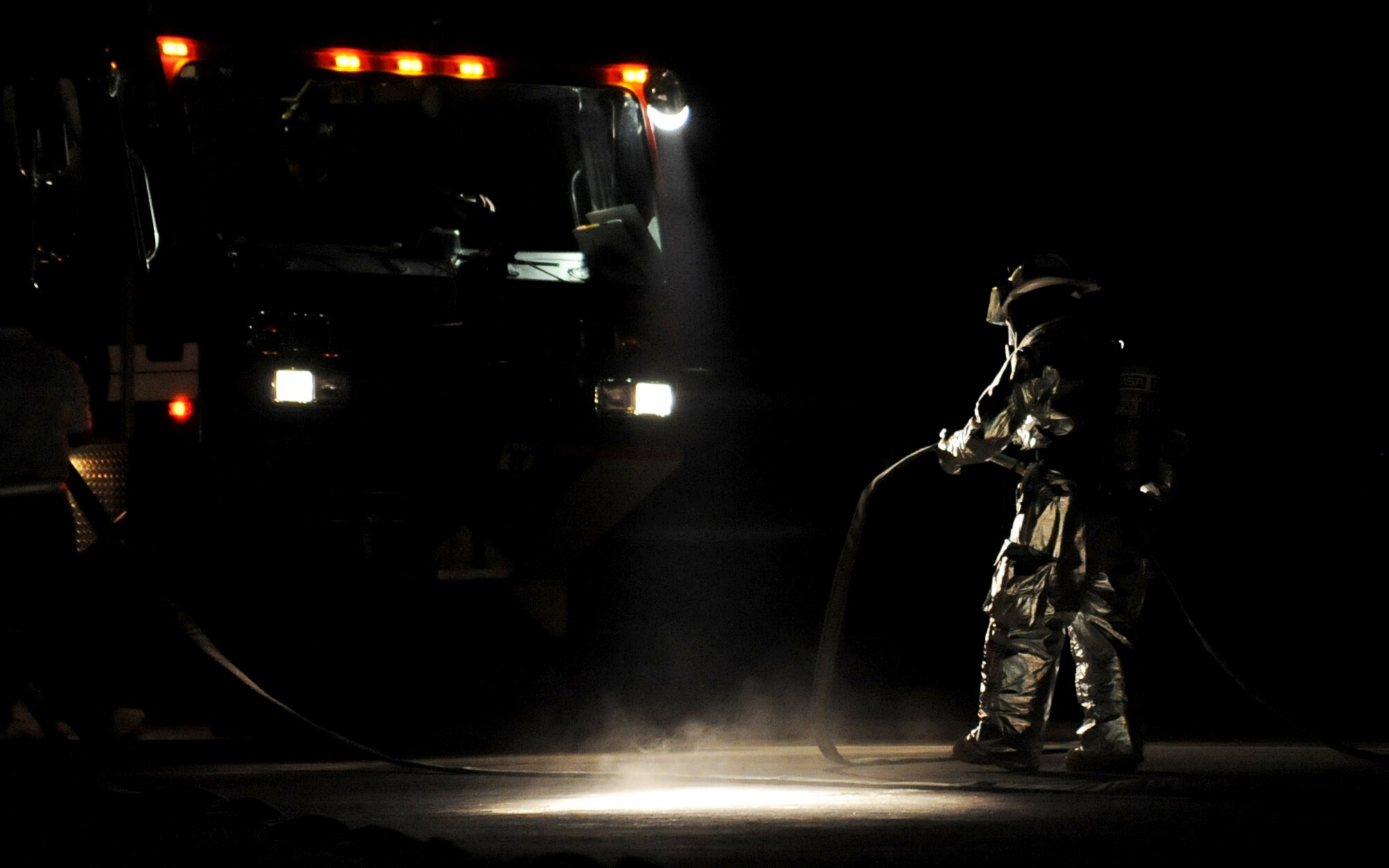 SOUTHWEST ASIA -- A firefighter from the 386th Expeditionary Civil Engineer Squadron checks his equipment before participating in live-fire training Oct. 27 at a U.S. military installation here. The firefighters used a Mobile Aircraft Firefighter Trainer, or MAFT, to hone their skills and work more closely together as a team. Live-fire training is an annual requirement for all USAF firefighters. (U.S. Air Force photo by Senior Airman Laura Turner)