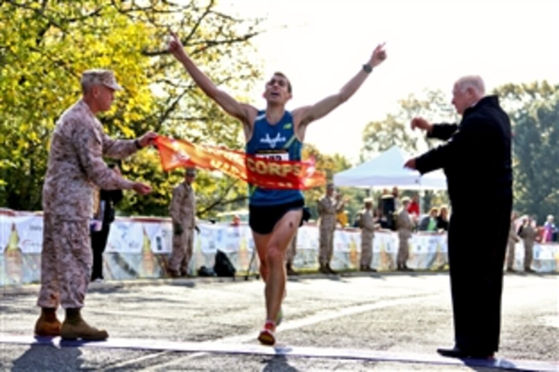 U.S. Air Force 2nd Lt. Jacob Bradosky crosses the finish line to win the 35th Marine Corps Marathon in Arlington, Va., Oct. 31, 2010. Bradosky, stationed on Vandenberg Air Force Base, Calif., finished the 26.2-mile journey in 2:23:30.