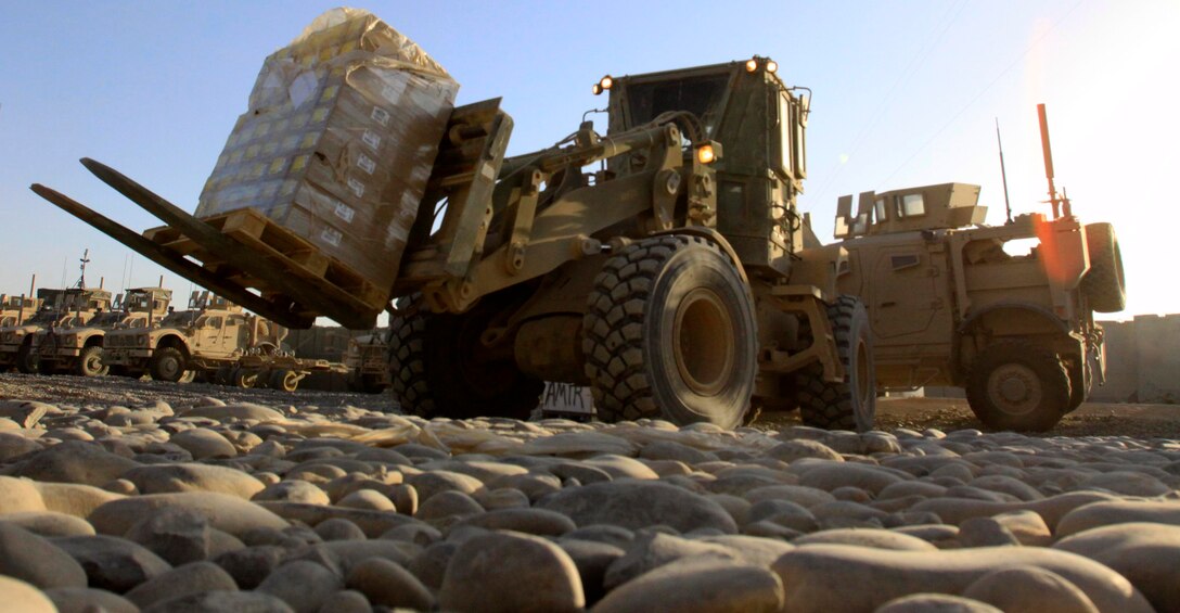 Marines with Motor Transport Company A, Combat Logistics Battalion 3, 1st Marine Logistics Group (Forward), use material handling equipment known as a Tractor, Rubber-tired, Articulated steering, Multi-purpose vehicle, or TRAM, to deliver supplies to units stationed on Forward Operating Base Delhi, Afghanistan, Nov. 1. The Motor Transport companies help CLB-3 accomplish their mission of providing combat logistics support to units within Regimental Combat Team 1 by moving supplies throughout Afghanistan's Helmand province.
