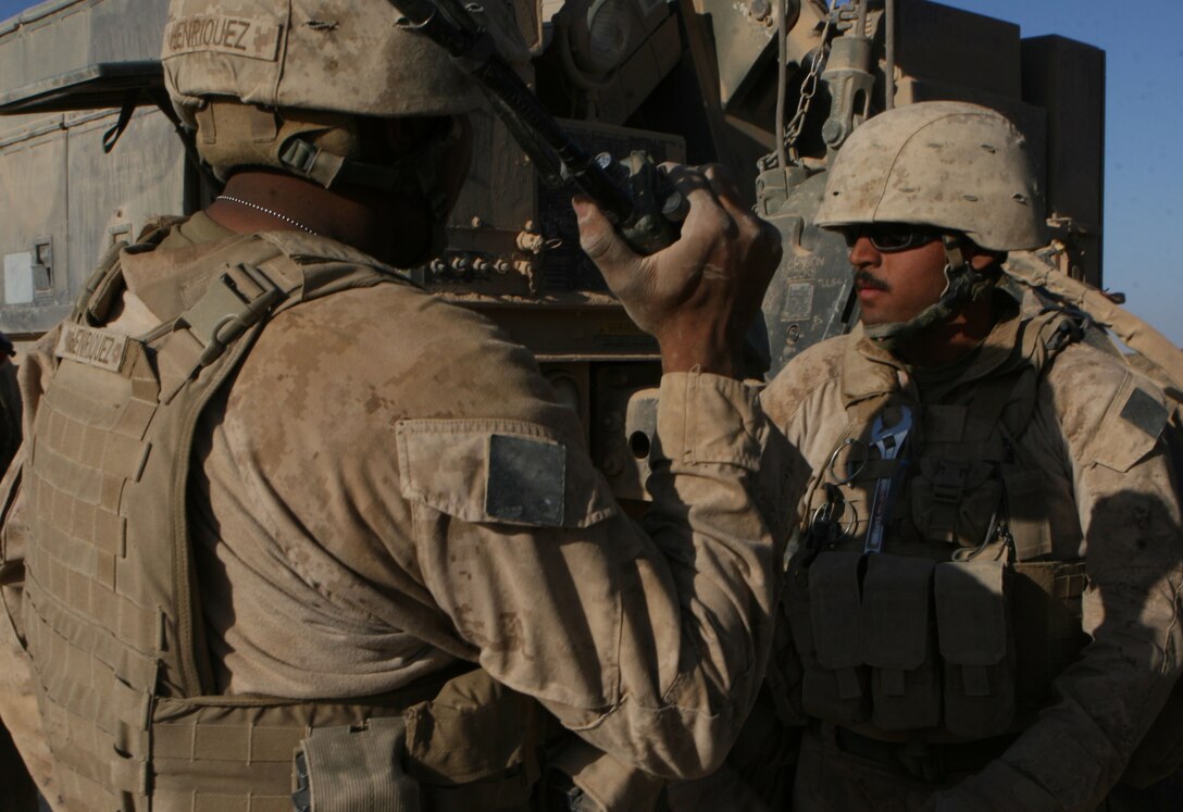 Sgt. Alex Cabreal, wrecker operator and Lance Cpl. Anthony R. Henriquez, a motor transport mechanic, both attached to Motor Transport Company B, Combat Logistics Battalion 3, 1st Marine Logistics Group (Forward), await instruction from the assistant convoy commander after successfully rigging a 7-ton for tow, Nov. 1. The wrecker crew had approximately 53 successful recoveries during the span of Operation Steel Dawn II.
