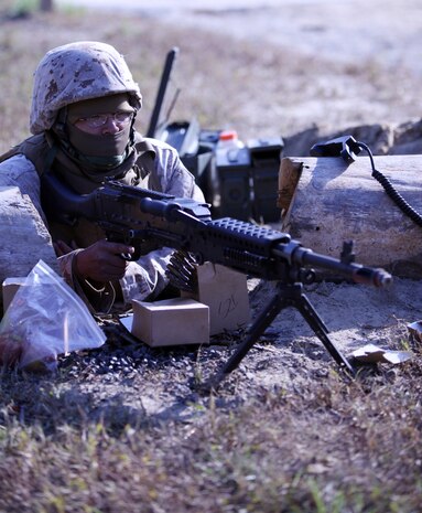 Cpl. Kevin Xiong, a supply administration specialist with 2nd Medical Battalion, Combat Logistics Regiment 25, 2nd Marine Logistics Group, stands guard in a trench with a M-240 Gulf Medium machine gun during a field exercise aboard Camp Lejeune, N.C., Nov. 2, 2010. The battalion participated in the five-day training evolution from Oct. 30 to Nov. 4 at the base’s Military Operations on Urban Terrain training facility, known as MOUT Town, in preparation for their upcoming deployment to Afghanistan. (U.S. Marine Corps photo by Pfc. Franklin E. Mercado)