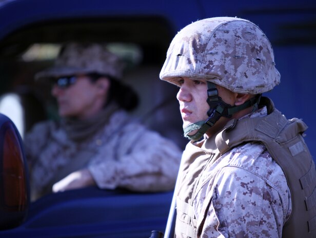 Lance Cpl. Diego Monsalve, a supply administration specialist with 2nd Medical Battalion, Combat Logistics Regiment 25, 2nd Marine Logistics Group, verifies a vehicle as it enters a entrance control point during a field exercise aboard Camp Lejeune, N.C., Nov. 2, 2010 The battalion participated in the five-day training evolution from Oct. 30 to Nov. 4 at the base’s Military Operations on Urban Terrain training facility, known as MOUT Town, in preparation for their upcoming deployment to Afghanistan. (U.S. Marine Corps photo by Pfc. Franklin E. Mercado)
