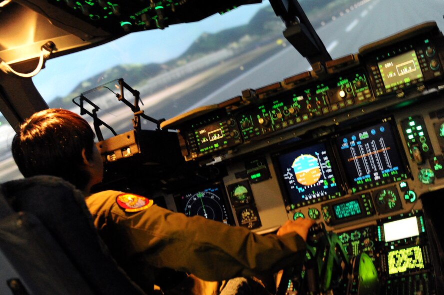 11-year-old Ryder Lum flies a C-17 simulator during his visit to Joint Base Pearl Harbor-Hickam Oct. 29, 2010. Ryder was part of the 535th Airlift Squadron’s quarterly Pilot for a Day program, which allows children with catastrophic disorders or illnesses to experience a day in the life of an Air Force pilot. Ryder was diagnosed with a cancerous brain tumor four years ago and has been in remission for almost two years. (U.S. Air Force photo/Staff Sgt. Carolyn Viss)