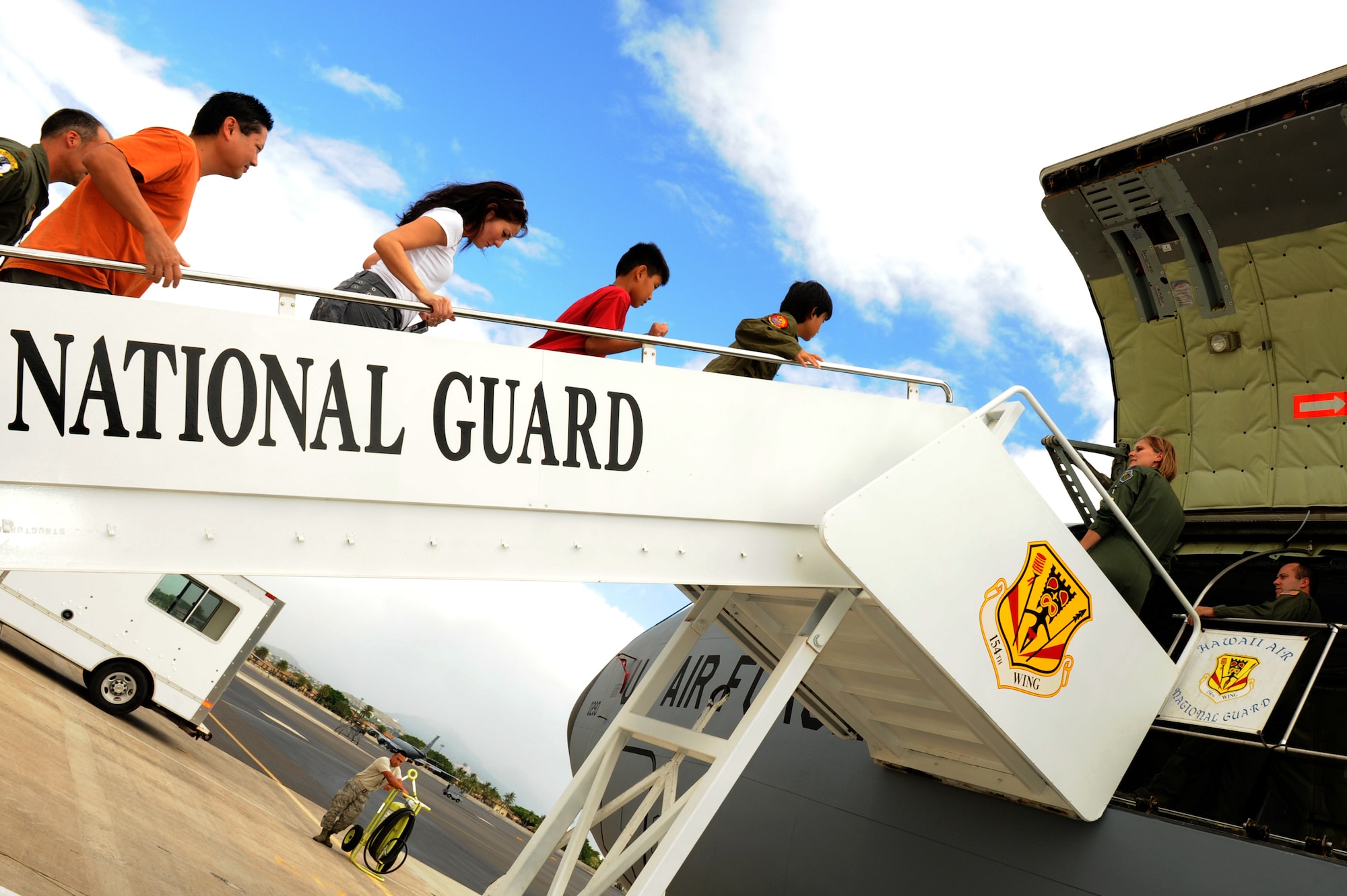 Ryder Lum, his parents Richelle and David, and his best friend Everett Fan, climb the air stairs into a Hawaii Air National Guard KC-135 on the flight line at Joint Base Pearl Harbor-Hickam Oct. 29, 2010. Ryder was part of the 535th Airlift Squadron’s quarterly Pilot for a Day program, which allows children with catastrophic disorders or illnesses to experience a day in the life of an Air Force pilot. Ryder was diagnosed with a cancerous brain tumor four years ago and has been in remission for almost two years. (U.S. Air Force photo/Staff Sgt. Carolyn Viss)