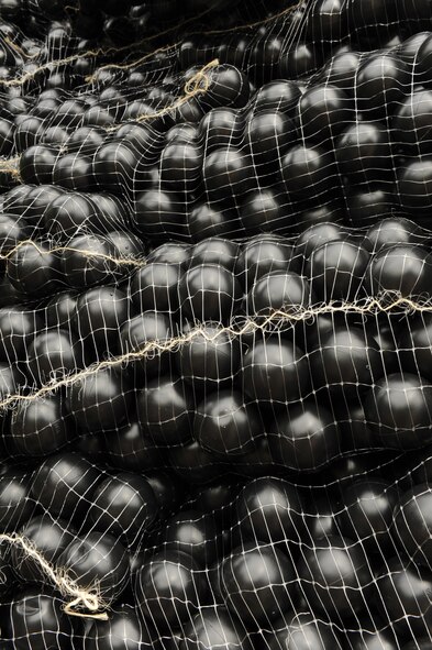JOINT BASE PEARL HARBOR-HICKAM, Hawaii - More than 70,000 "Armor Ball's" lay in the back of a semi truck here, Oct. 26. The Bird Hazard Working Group initiated the bird hazard abatement as part of the Bird/Wildlife Aircraft Strike Hazard, also know as the BASH program, when members of 647th Services Squadron, 647th Contracting Squadron, 15th Wing safety office and Mamala Bay Golf Course workers released “Armor Balls” into the reservoir. (U.S. Air Force photo/Senior Airman Gustavo Gonzalez)
 