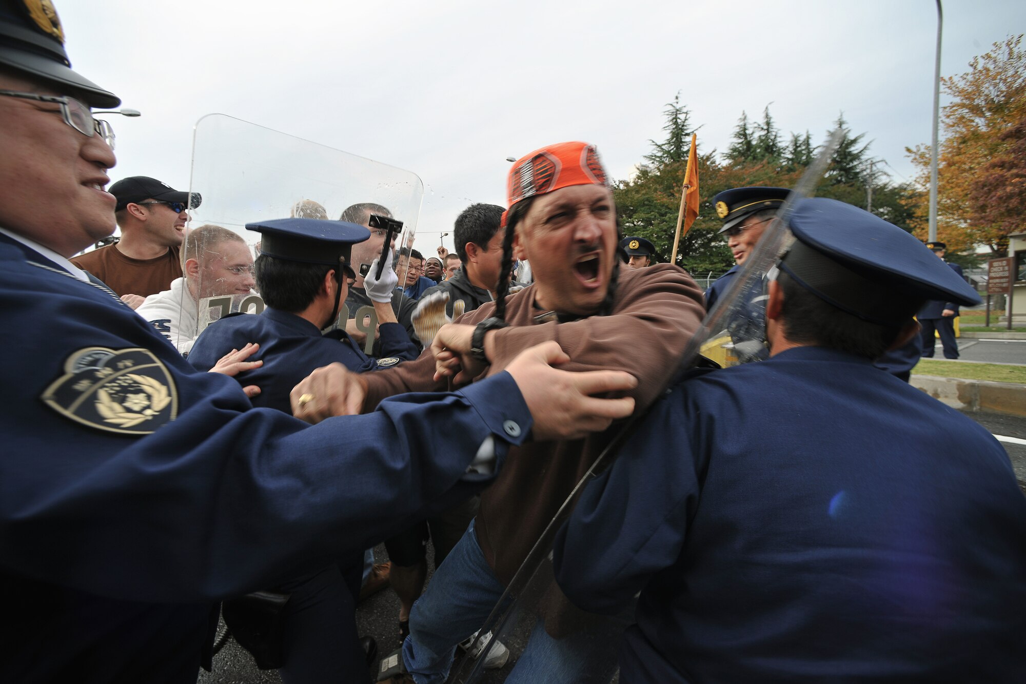 YOKOTA AIR BASE, Japan -- Exercise roleplayer Master Sgt. James Mings from 374th Airlift Wing Inspector General's office, clashes with police during a Joint Confrontation Management Exercise.  The 374th Security Forces Squadron hosted the exercise in conjunction with members of the 7th Riot Police, Tokyo Metropolitan Police Department, here Nov. 2. (U.S. Air Force photo/Osakabe Yasuo)
