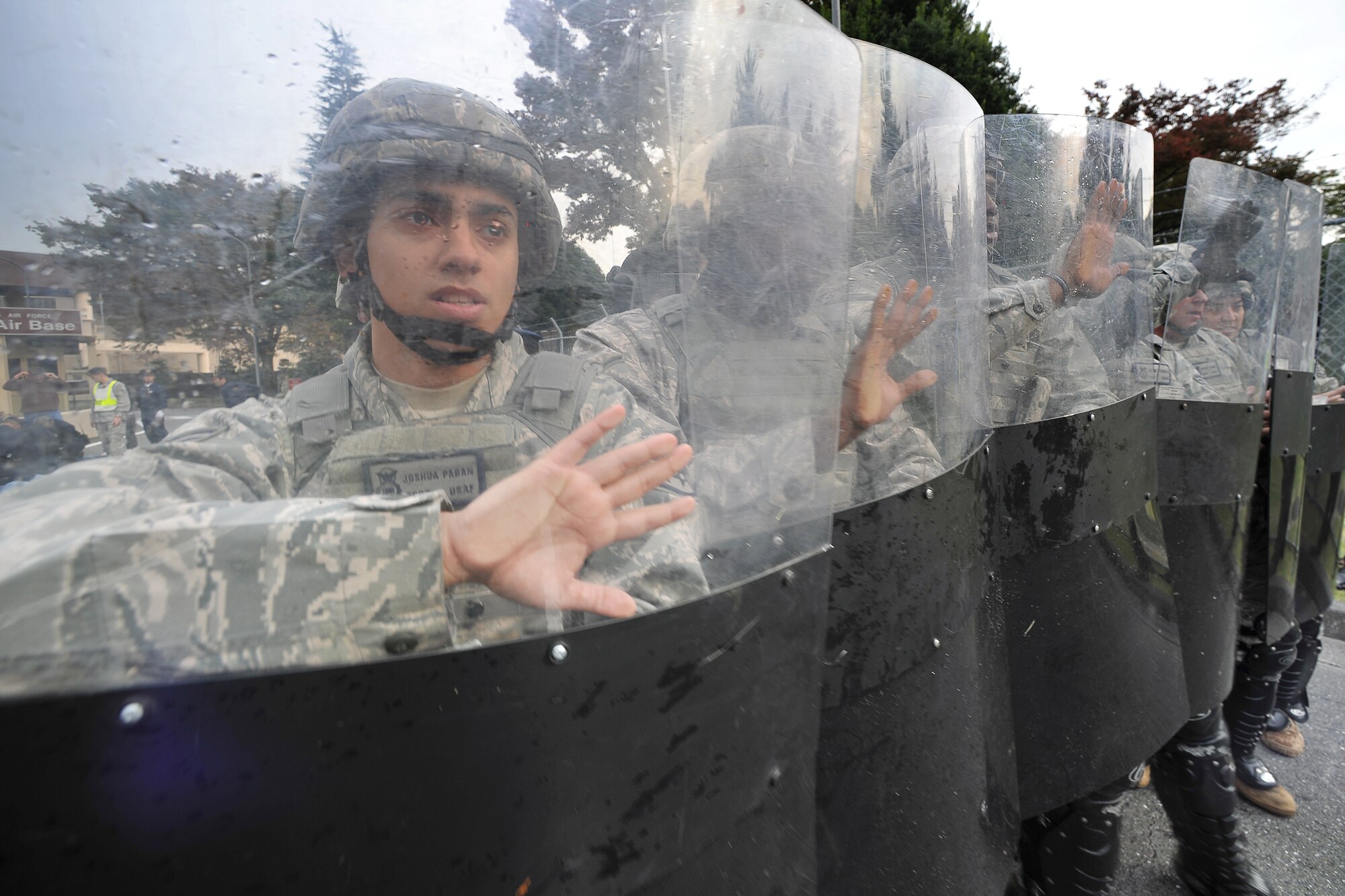 YOKOTA AIR BASE, Japan -- Members of confrontation management team from the 374th Security Forces Squadron perform a confrontation management manuever.  The 374 SFS conducted its first-ever Joint Confrontation Management Exercise with member of the 7th Riot Police, Tokyo Metropolitan Police Department, here Nov. 2. (U.S. Air Force photo/Osakabe Yasuo)