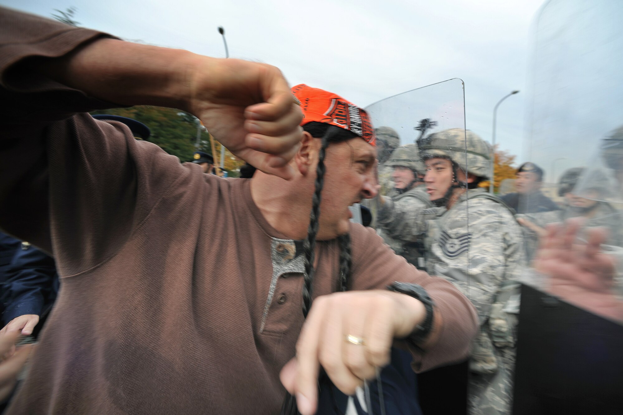 YOKOTA AIR BASE, Japan -- Master Sgt. James Mings from the 374th Airlift Wing Inspector General's office, clashes with police during an exercise here Nov. 2.  The 374th Security Forces Squadron conducted its first-ever Joint Confrontation Management Exercise with members of the 7th Riot Police, Metropolitan Police Department. (U.S. Air Force photo/Osakabe Yasuo)
