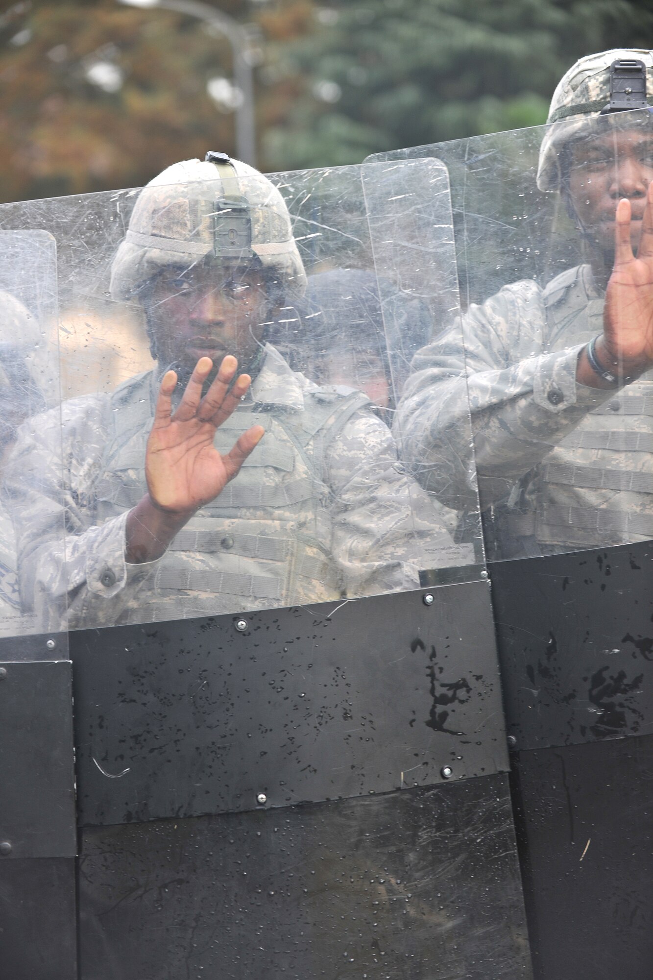YOKOTA AIR BASE, Japan -- Members of confrontation management team from the 374th Security Forces Squadron perform a confrontation management manuever. The 374 SFS conducted its first-ever Joint Confrontation Management Exercise with members of the 7th Riot Police, Tokyo Metropolitan Police Department, here Nov. 2.  (U.S. Air Force photo/Osakabe Yasuo)