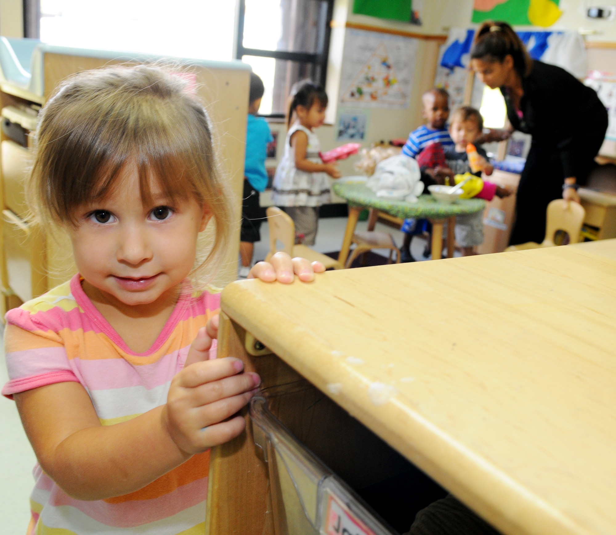 Marina Aguirre poses for a photo in her classroom during play time at the Andersen Air Force Base, Guam, Child Development Center Oct. 18. (U.S. Air Force photo/ Senior Airman Nichelle Anderson)