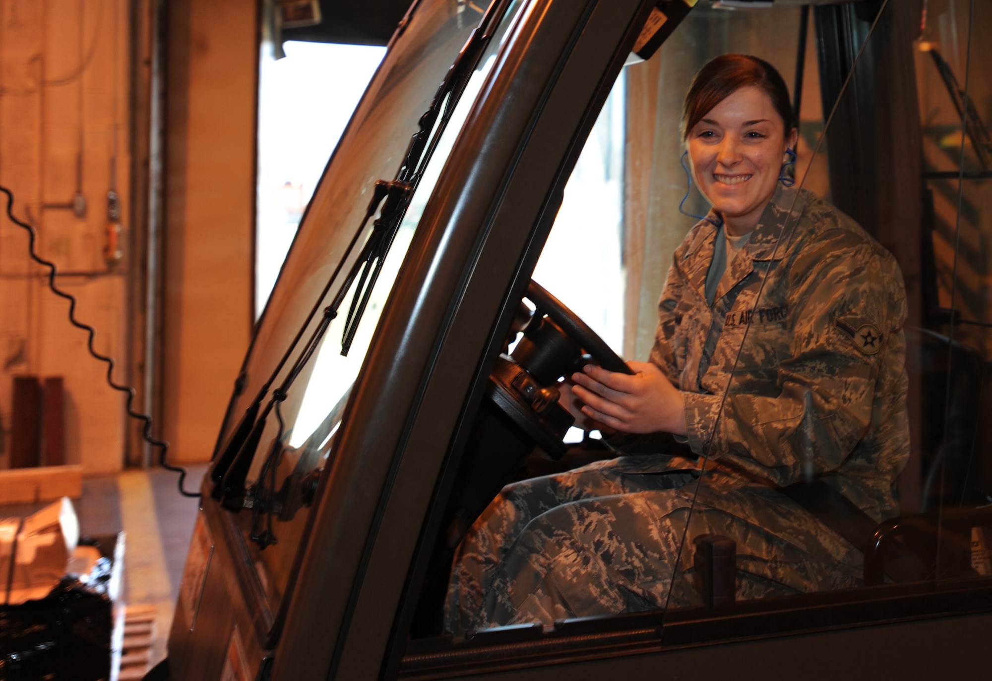 Airman Kassandra Ryman, 22nd Logistics Readiness Squadron transportation apprentice, pauses after delivering a shipment of supplies Oct. 29, 2010, McConnell Air Force Base, Kan. Airman Ryman ships packages from McConnell to locations Air Force-wide. The Waco, Texas, native also manages and processes delivered cargo from deployed locations. 