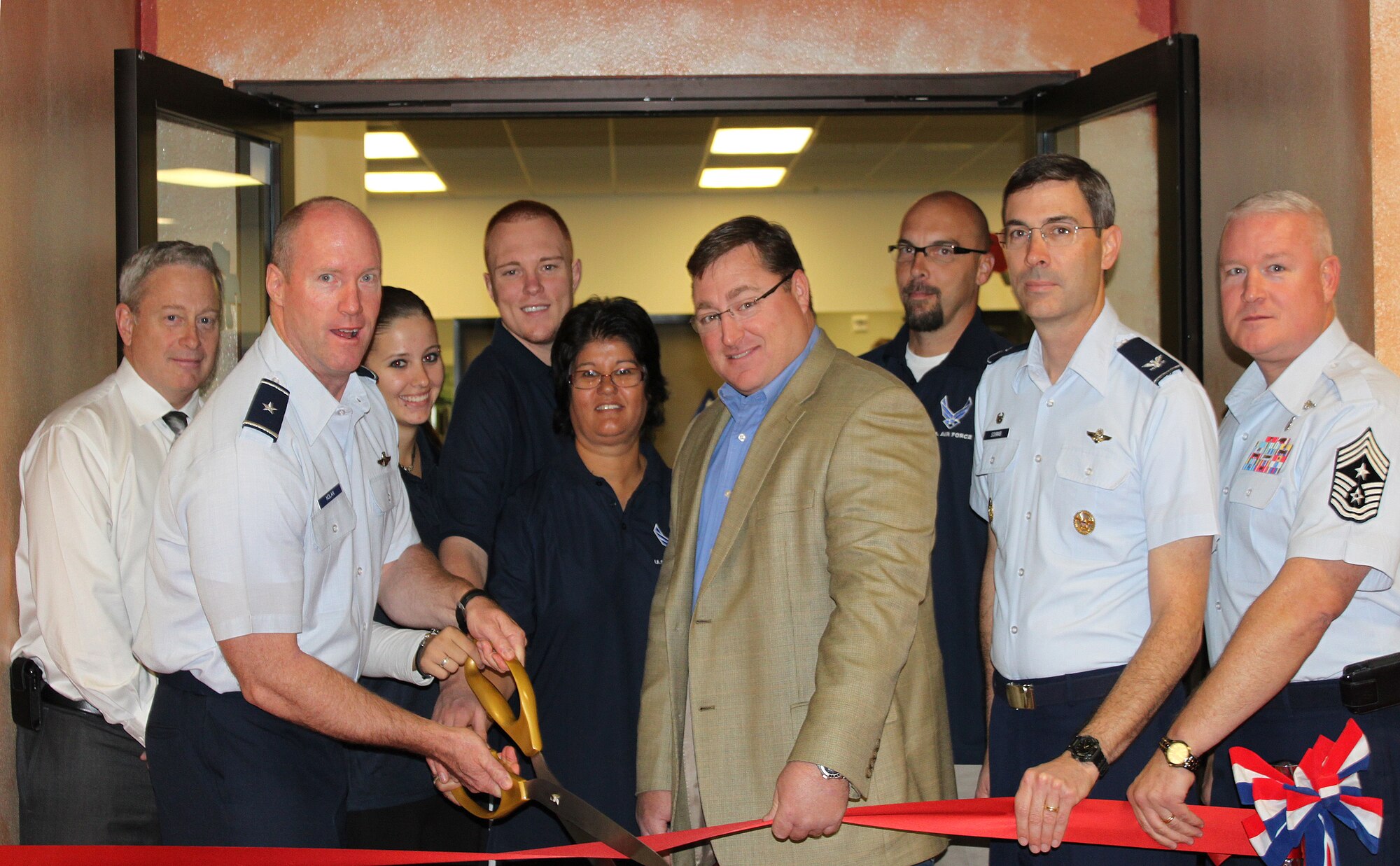 Front row, from left: Bruce Morrison, Force Support Squadron deputy director; Brig. Gen. Robert C. Nolan II, Air Force Flight Test Center commander; Pete Smith, Fitness Annex athletic director; Col. Gregory E. Schwab, 95th Air Base Wing commander; Chief Master Sgt. Bill Thomaston, 95th ABW command chief; help cut the ceremonial ribbon to officially open the Fitness Center Annex, Nov. 1. (Courtesy photo)