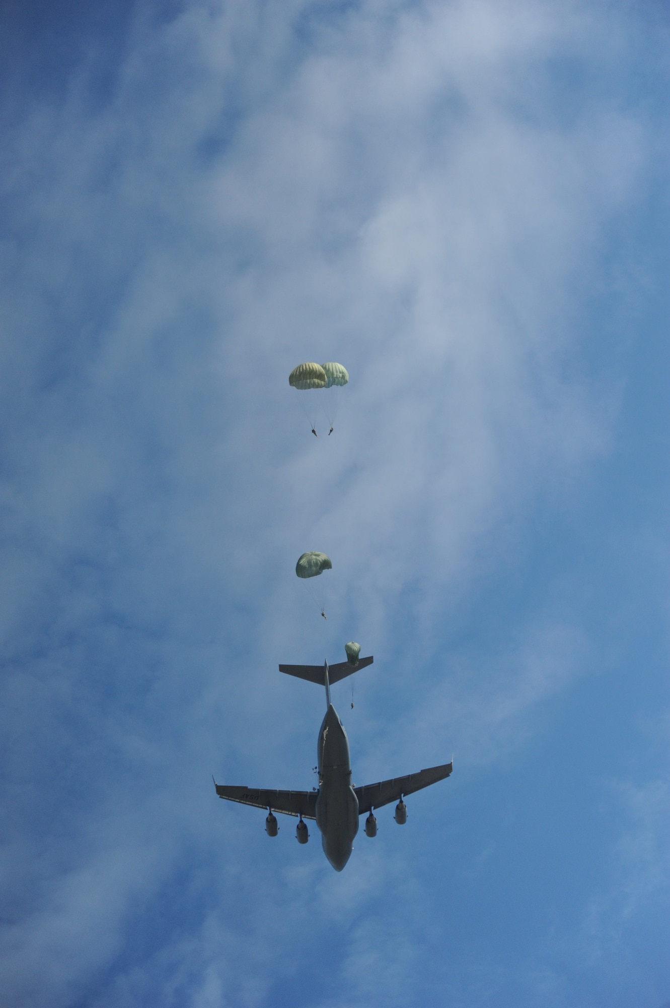 Paratroopers from the 507th Airborne School fall from the sky over Ft. Benning, Ga. after jumping out of a C-17 Globemaster from the 535th Airlift Squadron at Joint Base Pearl Harbor Hickam, Hi. Oct. 14. A C-17 from the 15th Wing made the long journey from Hawaii to Ft. Benning to support the student jump requirements of the 507th AS. (U.S. Air Force photo/Staff Sgt. Nathan Allen)
