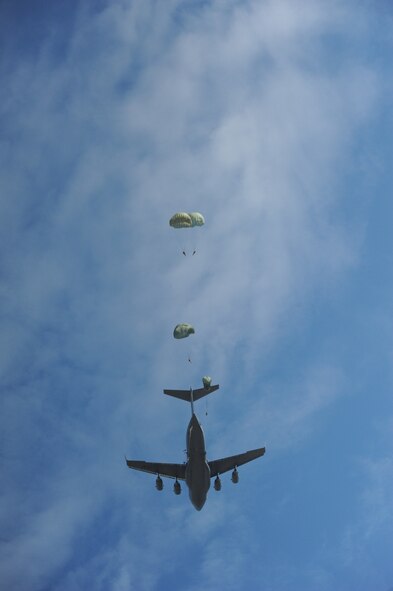 Paratroopers from the 507th Airborne School fall from the sky over Ft. Benning, Ga. after jumping out of a C-17 Globemaster from the 535th Airlift Squadron at Joint Base Pearl Harbor Hickam, Hi. Oct. 14. A C-17 from the 15th Wing made the long journey from Hawaii to Ft. Benning to support the student jump requirements of the 507th AS. (U.S. Air Force photo/Staff Sgt. Nathan Allen)
