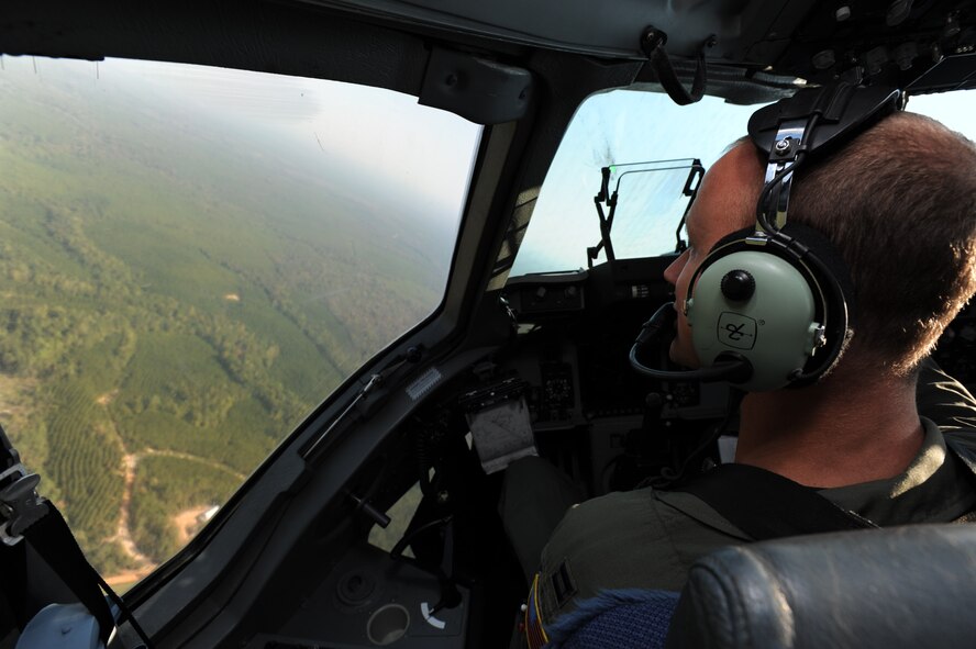Capt. Mark Fischer, 535th Airlift Squadron pilot from Joint Base Pearl Harbor Hickam, surveys the landscape during a turn Oct. 11 at Fort Benning, Ga. A C-17 Globemaster III from the 15th Wing made the long journey from Hawaii to Fort Benning to support the student jump requirements of the 507th Airborne School. (U.S. Air Force photo/Staff Sgt. Nathan Allen) 
