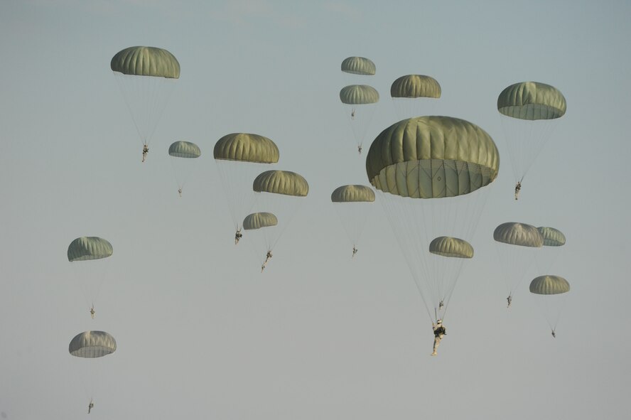 Paratroopers from the 507th Airborne School fall from the sky over Ft. Benning, Ga. after jumping out of a C-17 Globemaster from the 535th Airlift Squadron at Joint Base Pearl Harbor Hickam, Hi. Oct. 14. A C-17 from the 15th Wing made the long journey from Hawaii to Ft. Benning to support the student jump requirements of the 507th AS. (U.S. Air Force photo/Staff Sgt. Nathan Allen) 