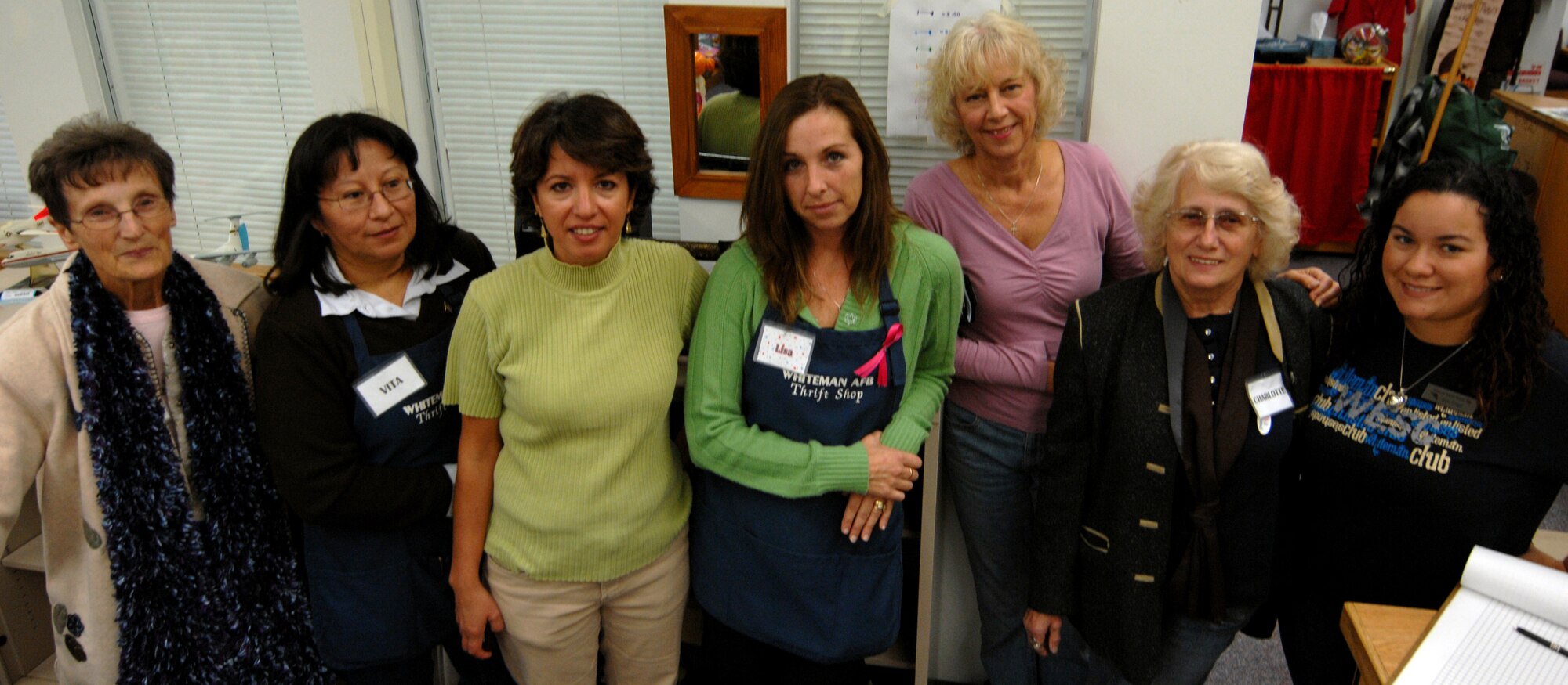 WHITEMAN AIR FORCE BASE, Mo. - Lisa Minckler (center) shows her modesty in highlighting her team of volunteers at the thrift store, Nov. 2. Mrs. Minckler was recognized as 509th Bomb Wing Volunteer of the Quarter, but she said her recognition was owed to every person who helped the store. (U.S. Photograph by Cody H. Ramirez)