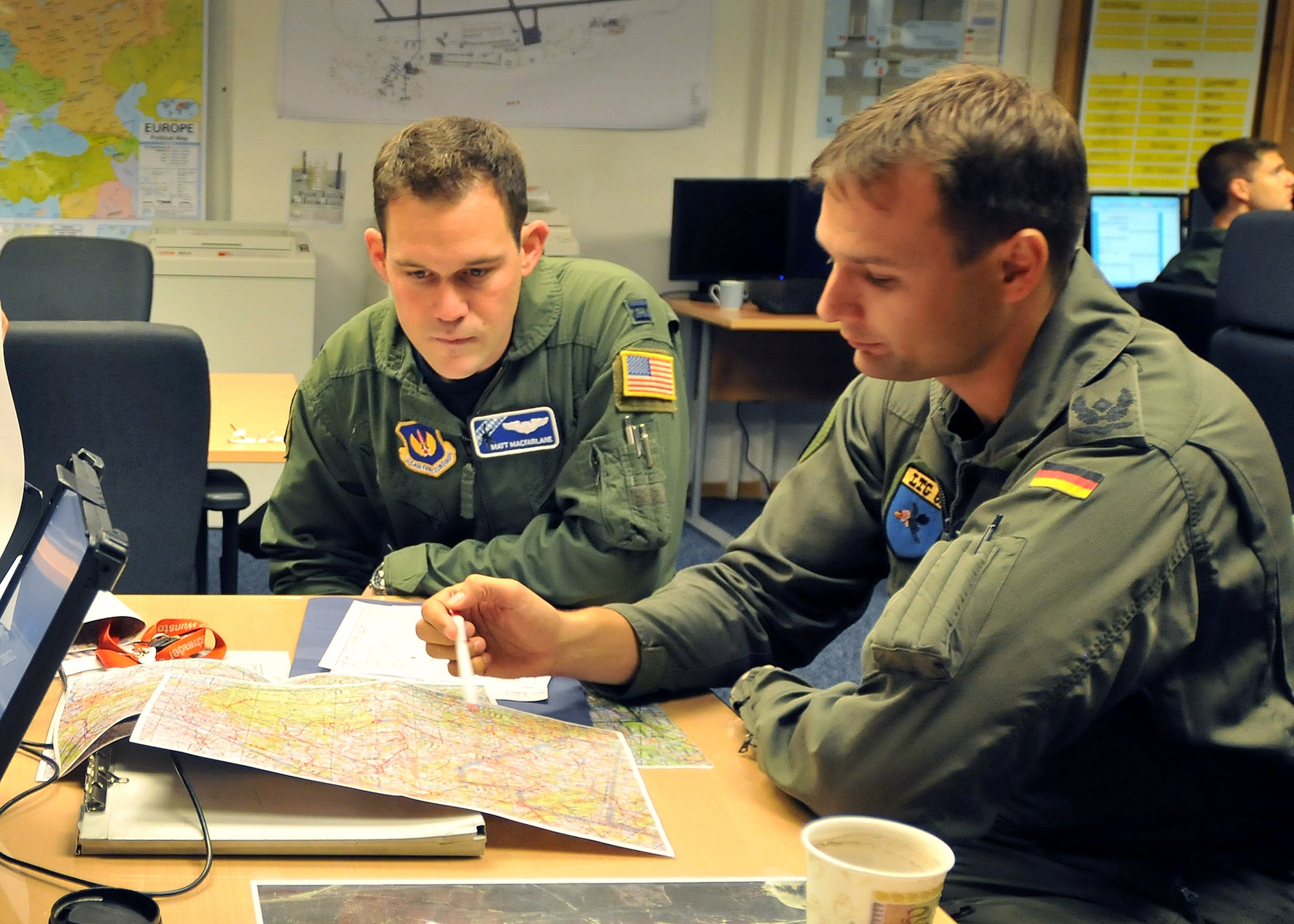 Capt. Matt Macfarlane (left) and German air force Maj. Stefan Schipke plan a joint training mission Oct. 28, 2010, at Ramstein Air Base, Germany. Eleven German aircrew members and two C-160 Transall aircraft spent a week training with the 37th AS members Oct. 25 through 29. Captain Macfarlane is a 37th AS tactics officer and Major Schipke is a Lufttransportgeschwader 62 squadron leader. (U.S. Air Force photo/Tech Sgt. Markus M. Maier)