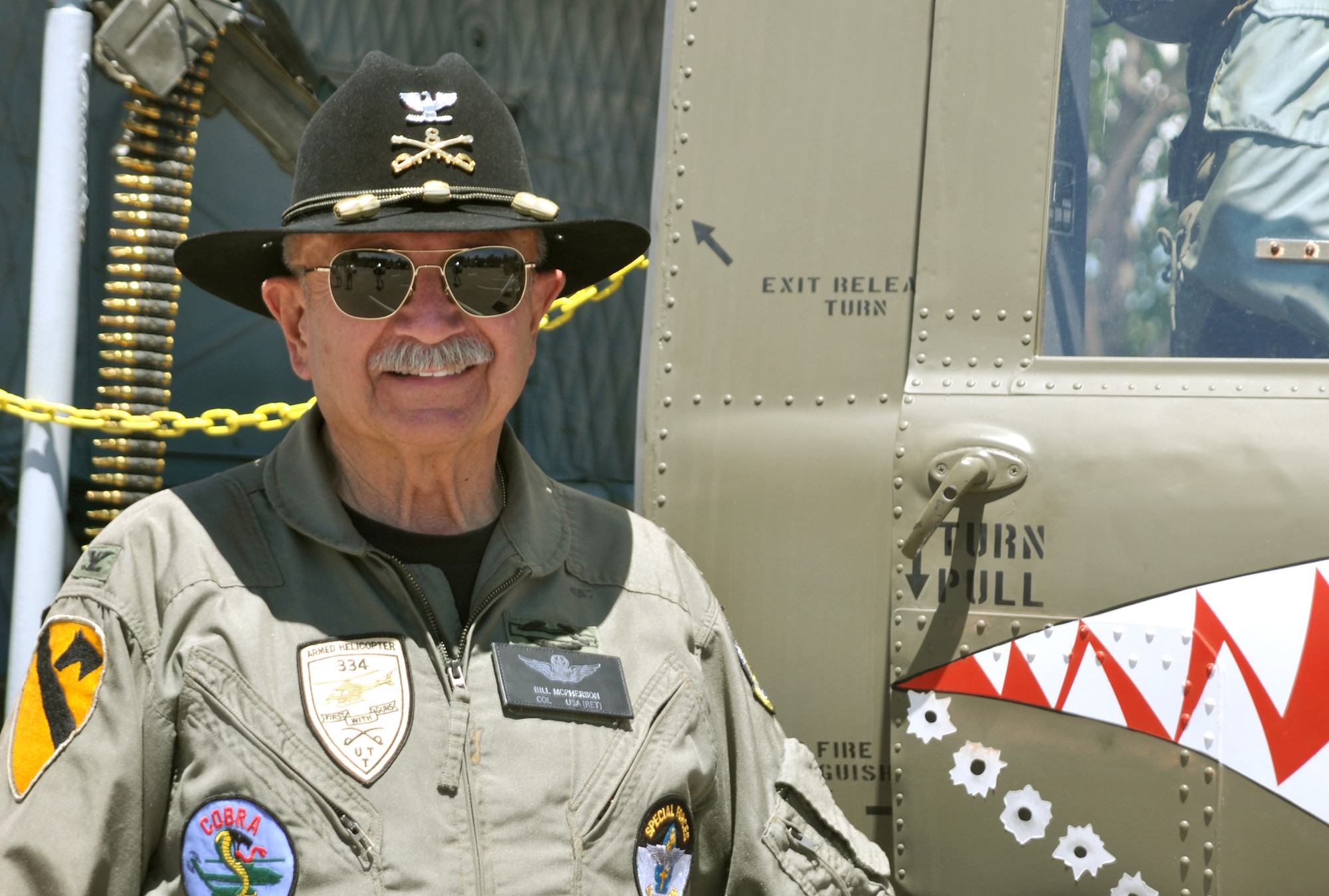 Retired Army Col. Bill McPherson is the honorary commander for the 34th Aeromedical Evacuation Squadron at the 302nd Airlift Wing at Peterson Air Force Base, Colo. Colonel McPherson displayed and gave tours of his restored UH-1 (M) Huey to 302nd AW families during the wing's Family Day. (U.S. Air Force photo/Ann Skarban)