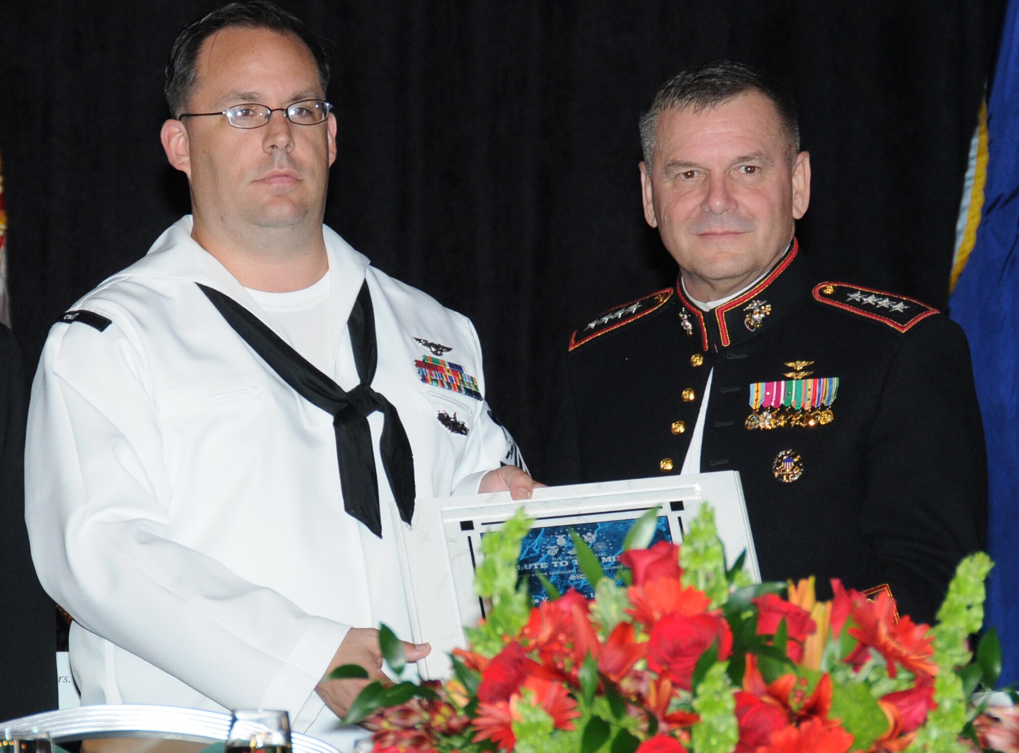 Petty Officer Sayers, left, and General Cartwright share the spotlight at the 32nd Annual Salute to the Military, Oct. 26 at the Mississippi Coast Coliseum Convention Center in Biloxi.  (U.S. Air Force photo by Kemberly Groue)
