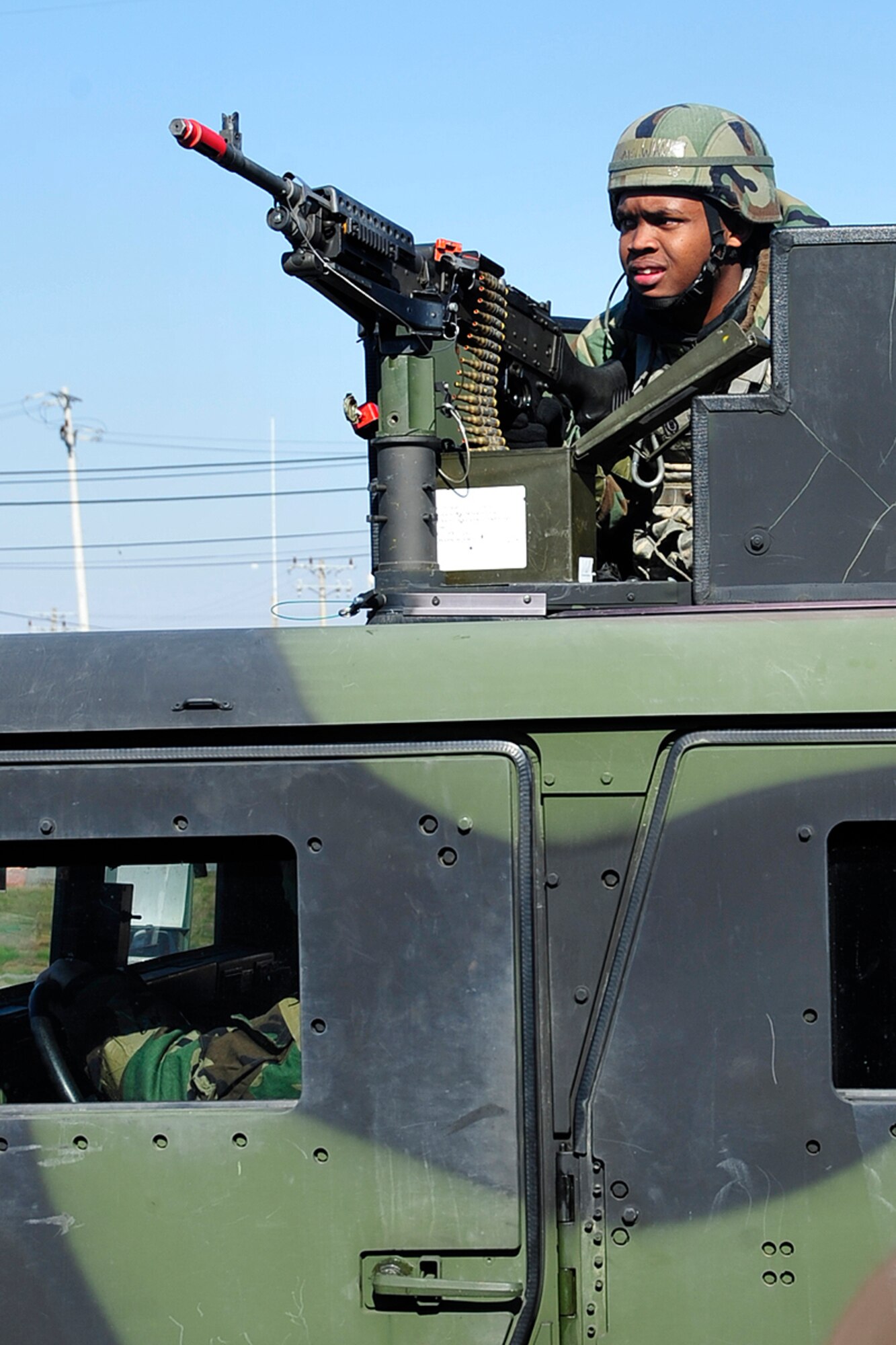 Airman 1st Class Carlos White, 51st Security Forces Squadron, mans a turrett gun Nov. 2 at Osan Air Base, Republic of Korea, during exercise Beverly Midnight 10-02. The exercise allows Airmen to demonstrate their ability to complete the mission in simulated chemical environments while executing their primary duties, practicing self aid and buddy care, conducting post-attack reconnaissance and unexploded ordnance sweeps. (U.S. Air Force photo/Staff Sgt. Eunique Stevens)