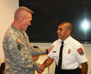SOTO CANO AIR BASE, Honduras - Joint Task Force Bravo commander Col. Greg Reilly congratulated Mr. Herberth Gaekel on being named Air Combat Command Civilian Firefighter of the Year for 2010.  Mr. Gaekel is a civilian fire inspector for the 612th Air Base Squadron fire department here. (US Air Force photo/Capt. John T. Stamm)