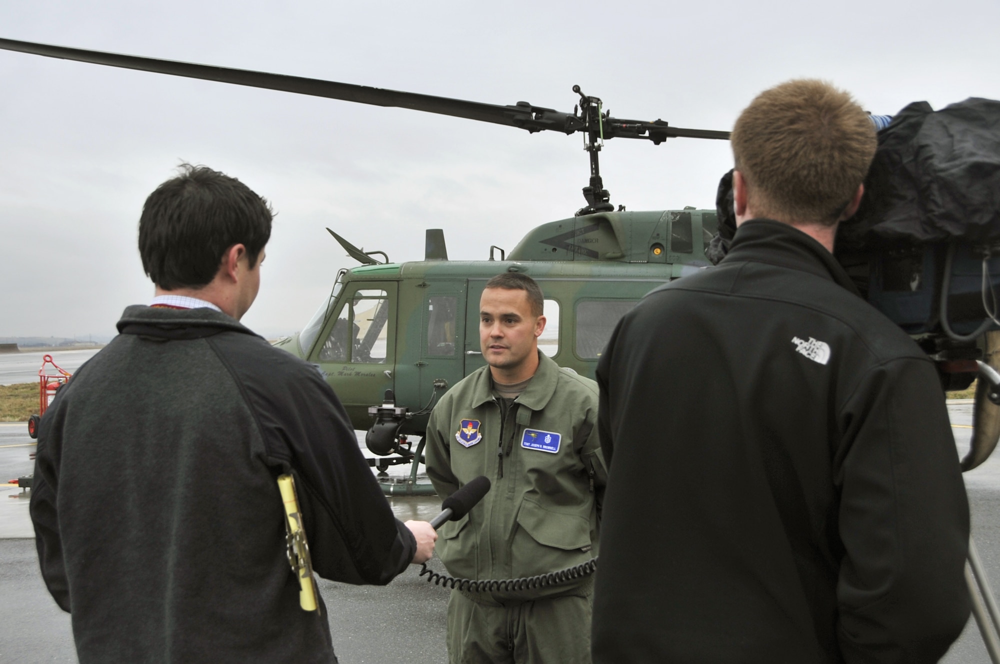 Media members interview Tech. Sgt. Joseph Brownell in front of a UH-1N Iroquois helicopter Oct. 28, 2010, at Fairchild Air Force Base, Wash. Sergeant Brownell, a medic with the 36th Rescue Flight, was one of five crew members who rescued six people that day. (U.S. Air Force photo/Staff Sgt. J.G. Buzanowski)