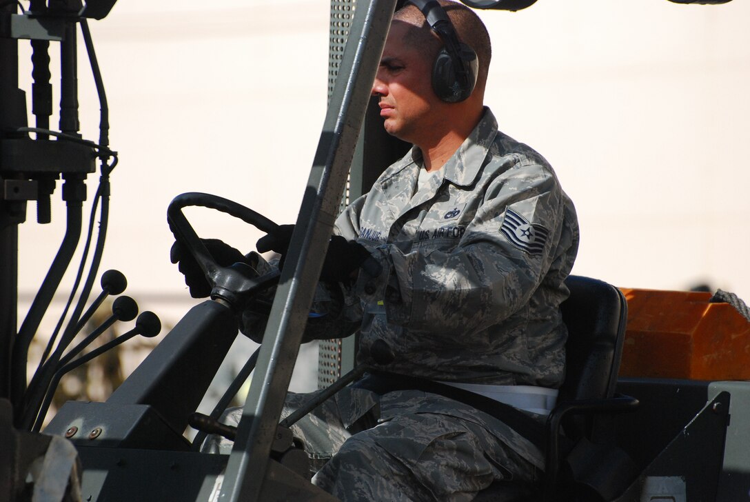 DOBBINS AIR RESERVE BASE, Ga. -- Tech Sgt. Rolando Sanjur, 69th Aerial Port Squadron, maneuvers a forklift while carrying a pallet during a competition event at the Air Force Reserve Command's Port Dawg Challenge here Oct. 27. The inaugural event pitted 23 different Reserve units against each other in a weeklong competition that tested the skills of aerial port Airmen. (U.S. Air Force photo/Tech. Sgt. Steve Lewis)
