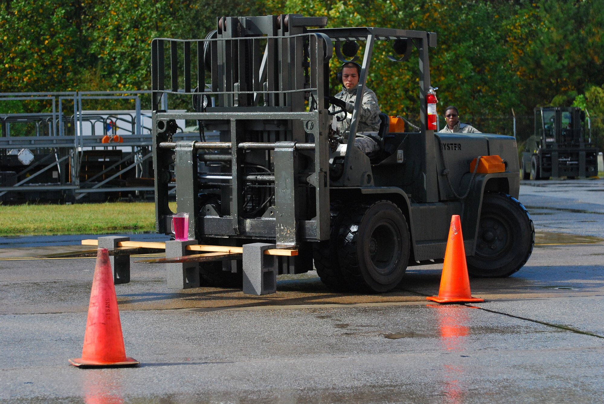 DOBBINS AIR RESERVE BASE, Ga. -- Staff Sgt. Diego Jainez, 69th Aerial Port Squadron, maneuvers a forklift while carrying a pitcher full of water that could not be spilled during a competition event at the Air Force Reserve Command's Port Dawg Challenge here Oct. 27. The inaugural event pitted 23 different Reserve units against each other in a weeklong competition that tested the skills of aerial port Airmen. (U.S. Air Force photo/Tech. Sgt. Steve Lewis)