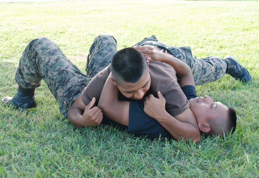 SOTO CANO AIR BASE, Honduras -- Two members of the Honduran Security Force "La Guardia" practice groundfighting techniques at during a joint Combatives Training course here Oct. 28.  Joint Security Forces here provides the members training on use of force, searching and handcuffing, vehicle searches, entry control measures, riot control, combatives and public interaction. (U.S. Air Force photo/Capt. John Stamm)