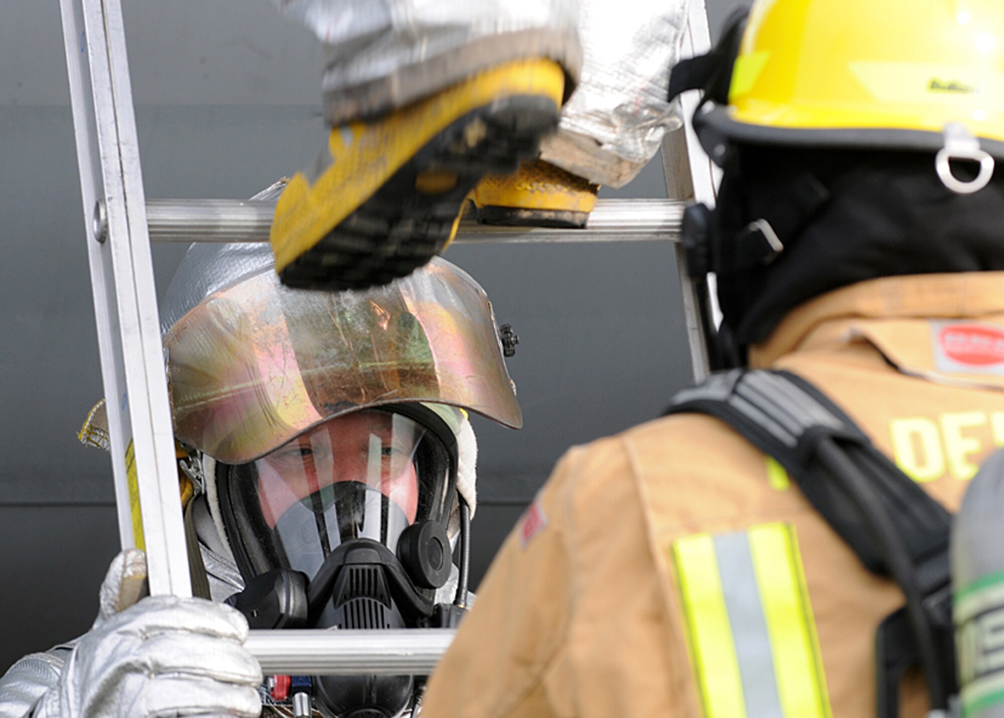RAF MILDENHALL, England - Firefighters from the 100th Civil Engineer Squadion use a ladder to access the fuselage of a KC-135 Stratotanker during a Major Accident Response Exercise here, Nov. 2, 2010.  A MARE is designed to prepare emergency response personnel for real-world emergencies.  (U.S. Air Force photos/Senior Airman Tabitha M. Lee) 