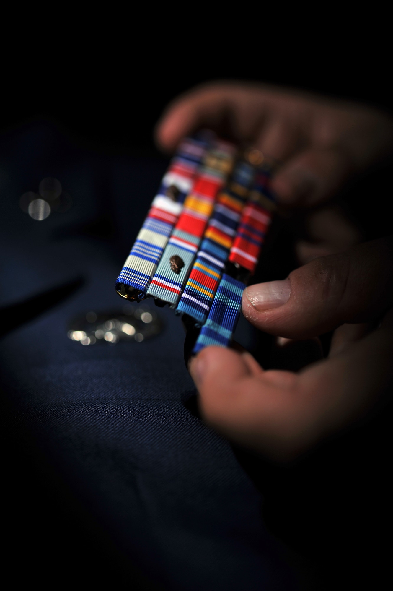509th Force Support Squadron Mortuary Affairs personnel assemble the last ribbon rack fallen Aimen will wear before they are laid to rest showing their career accomplishments. (U.S. Air Force photo by Tech. Sgt. Charles Larkin Sr.)