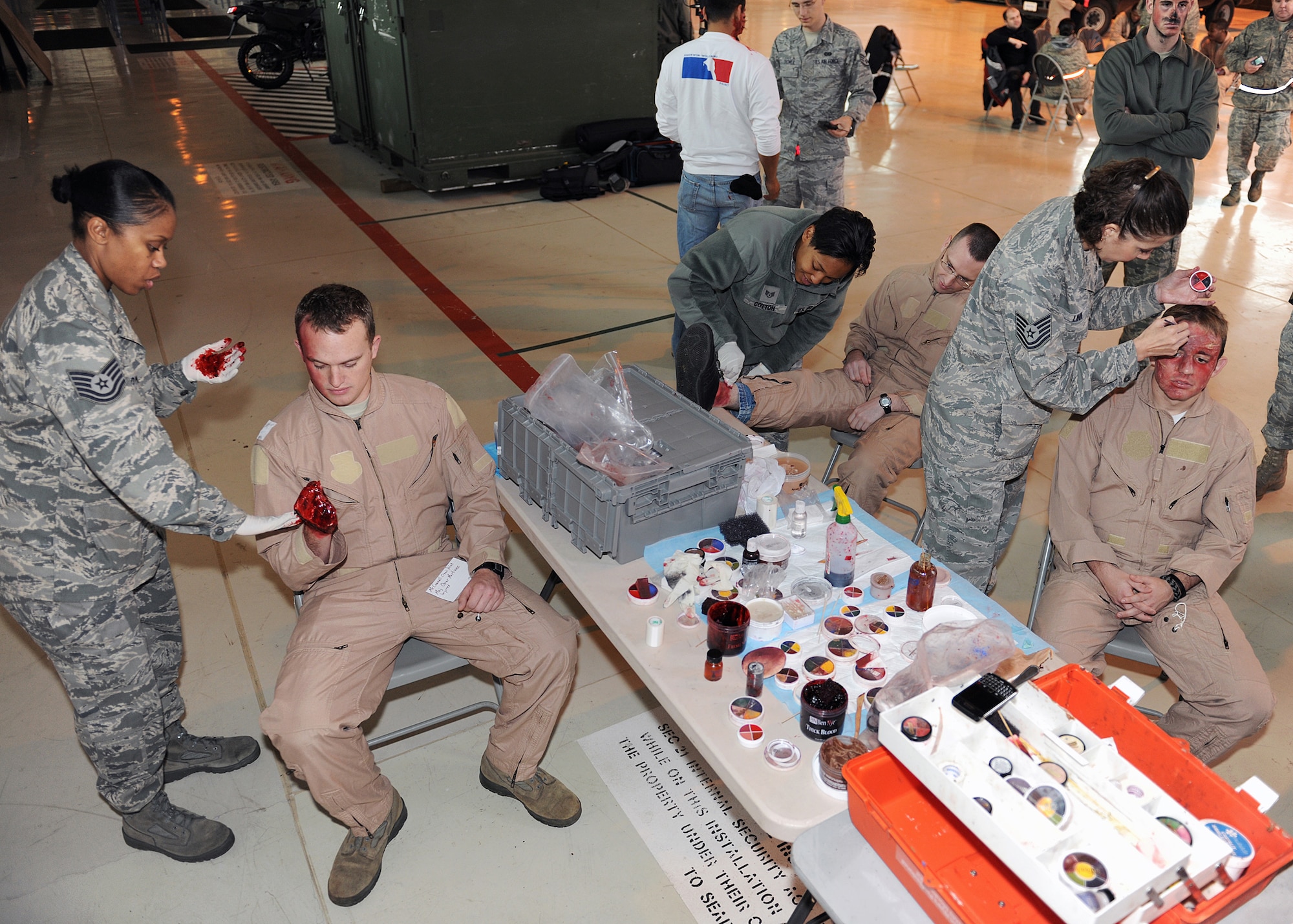 RAF MILDENHALL, England - Medical personnel apply moulage, premade rubber or latex "wounds" as well as complex makeup and theater techniques, to casualty volunteers before the Major Accident Response Exercise here, Nov. 2, 2010.  Moulage is used to make the training a more realistic experience for the emergency response personnel.  (U.S. Air Force photo/Senior Airman Tabitha M. Lee)  