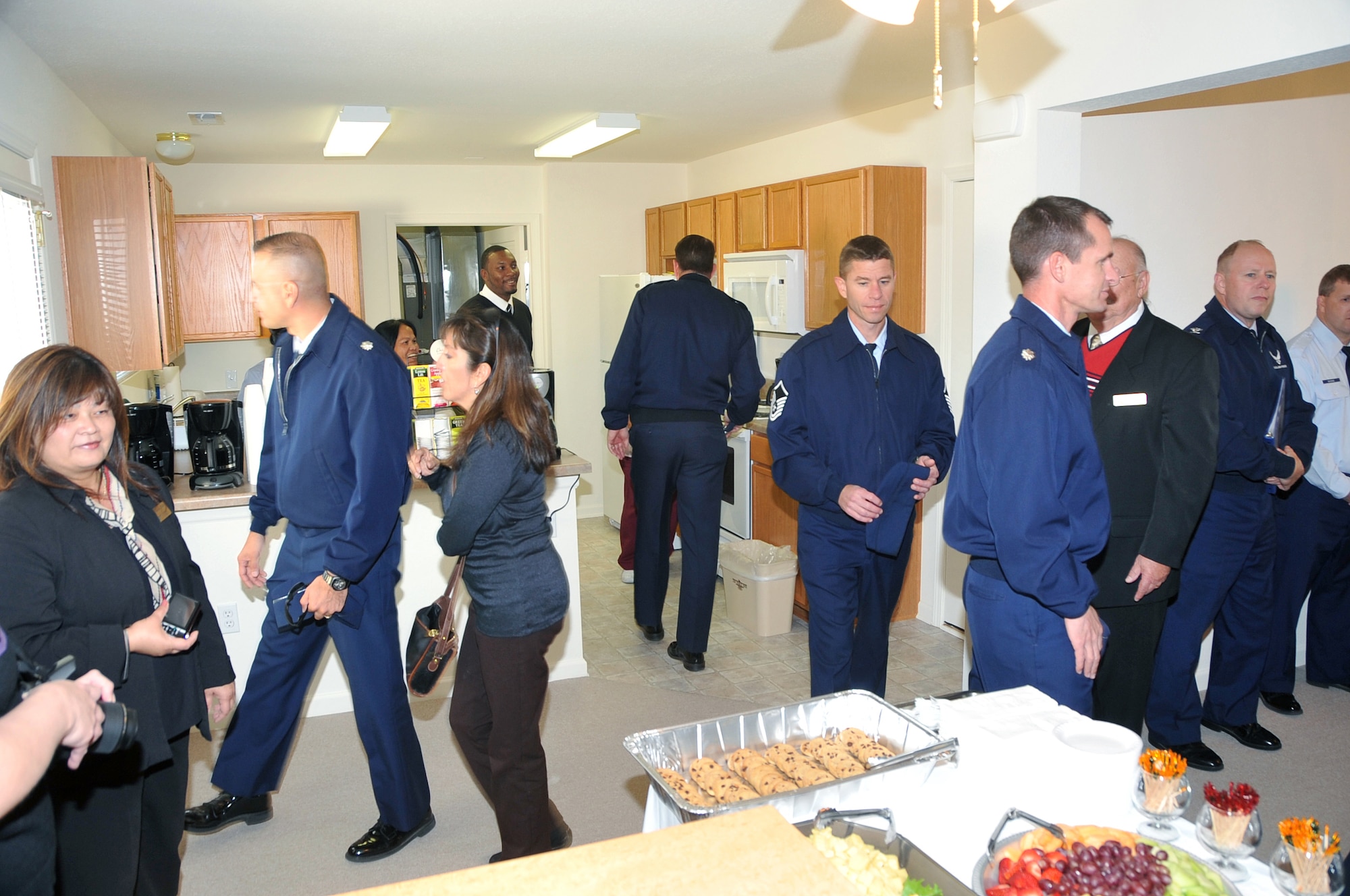 OFFUTT AIR FORCE BASE, Neb. - Patrons tour one of the new base temporary lodging facilities after an official ribbon-cutting ceremony Nov. 1. The base recently partnered with America First Communities, the company who runs Offutt's privatized military housing, to lease 30 new privatized single family units to make them available to military families coming in and out of Offutt. U.S. Air Force photo by Jeff W. Gates.
