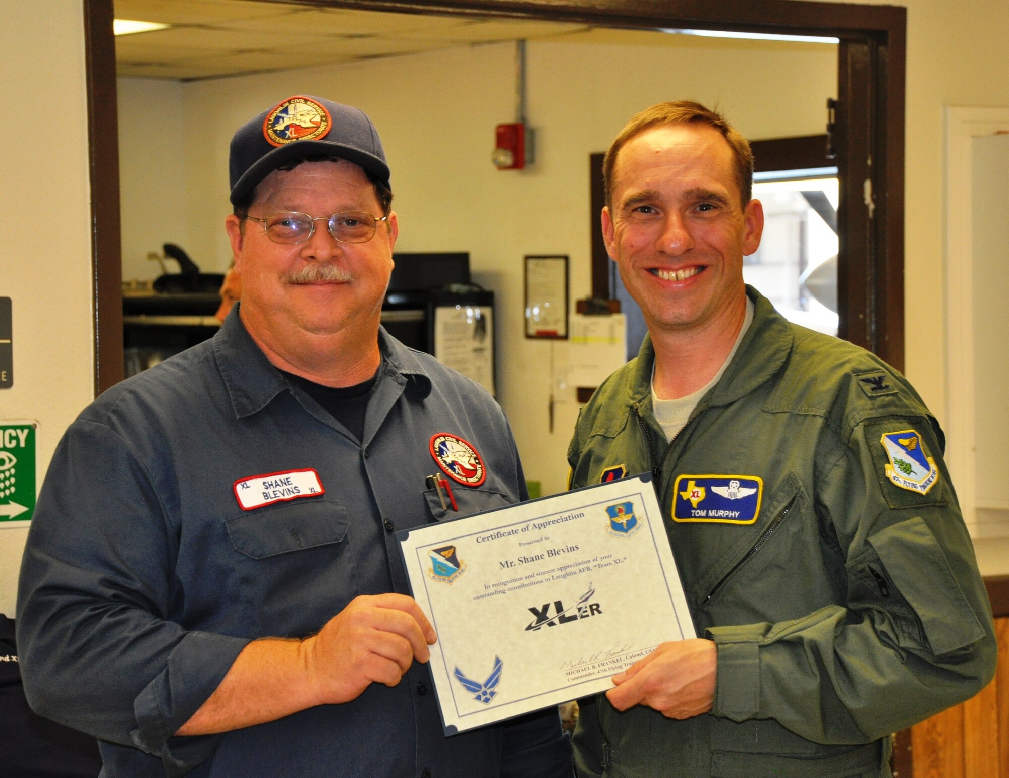 LAUGHLIN AIR FORCE BASE, Texas – Shane Blevins, 47th Maintenance Directorate, poses with Col. Thomas Murphy, 47th Flying Training Wing vice commander, after being presented the XLer of the Week award here Oct. 27. The XLer is a weekly award chosen by wing leadership and given to individuals who continuously make outstanding contributions to Laughlin and their unit. (U.S. Air Force photo by 2nd Lt. Travis Antoniono)