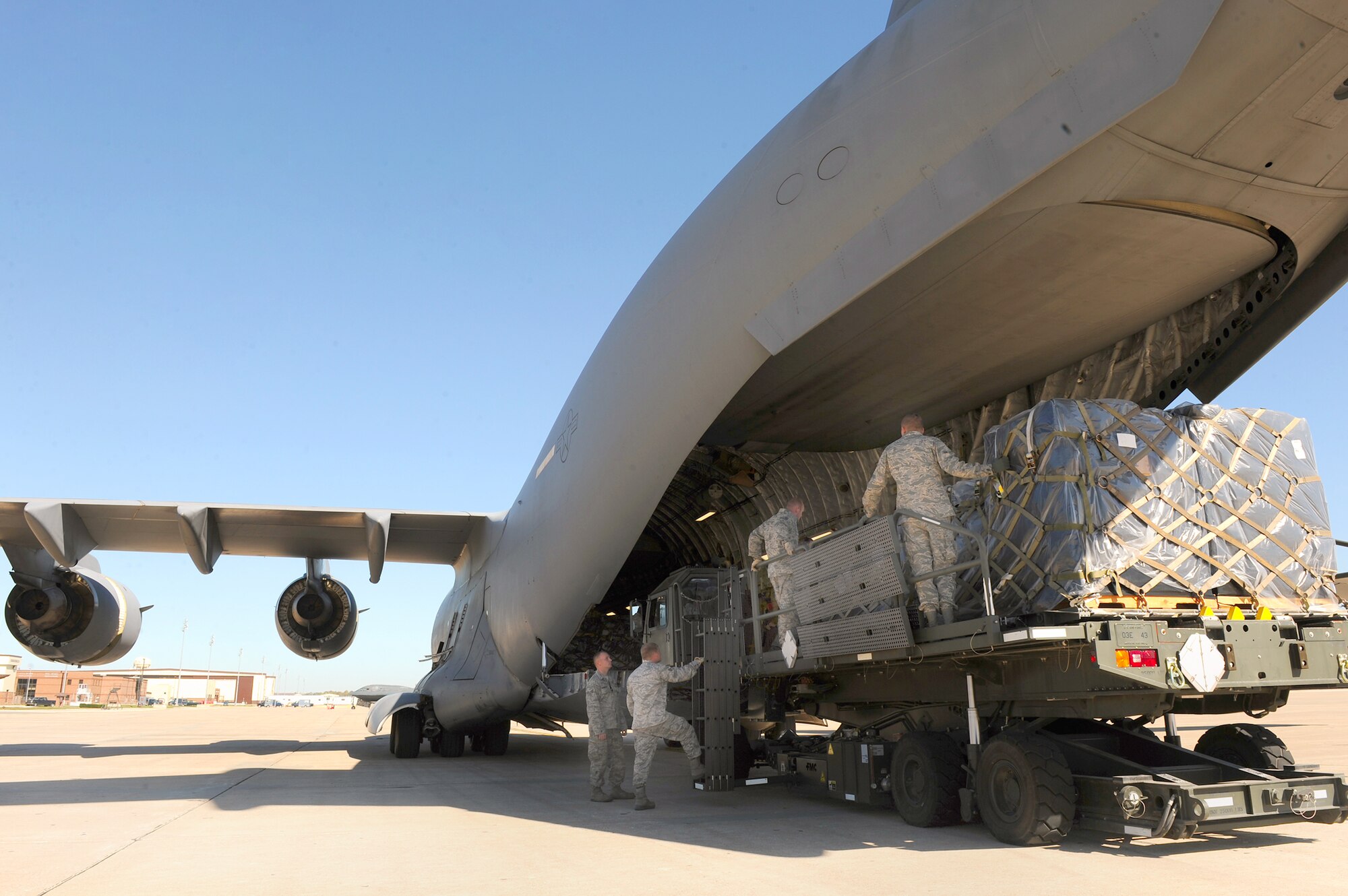 Airmen with the 509th Logistics Readiness Squadron load humanitarian aid cargo onto a C-17 Globemaster III, Oct 17, 2010 to be shipped to people in need in Honduras. (U.S. Air Force photo/Senior Airman Kenny Holston)

