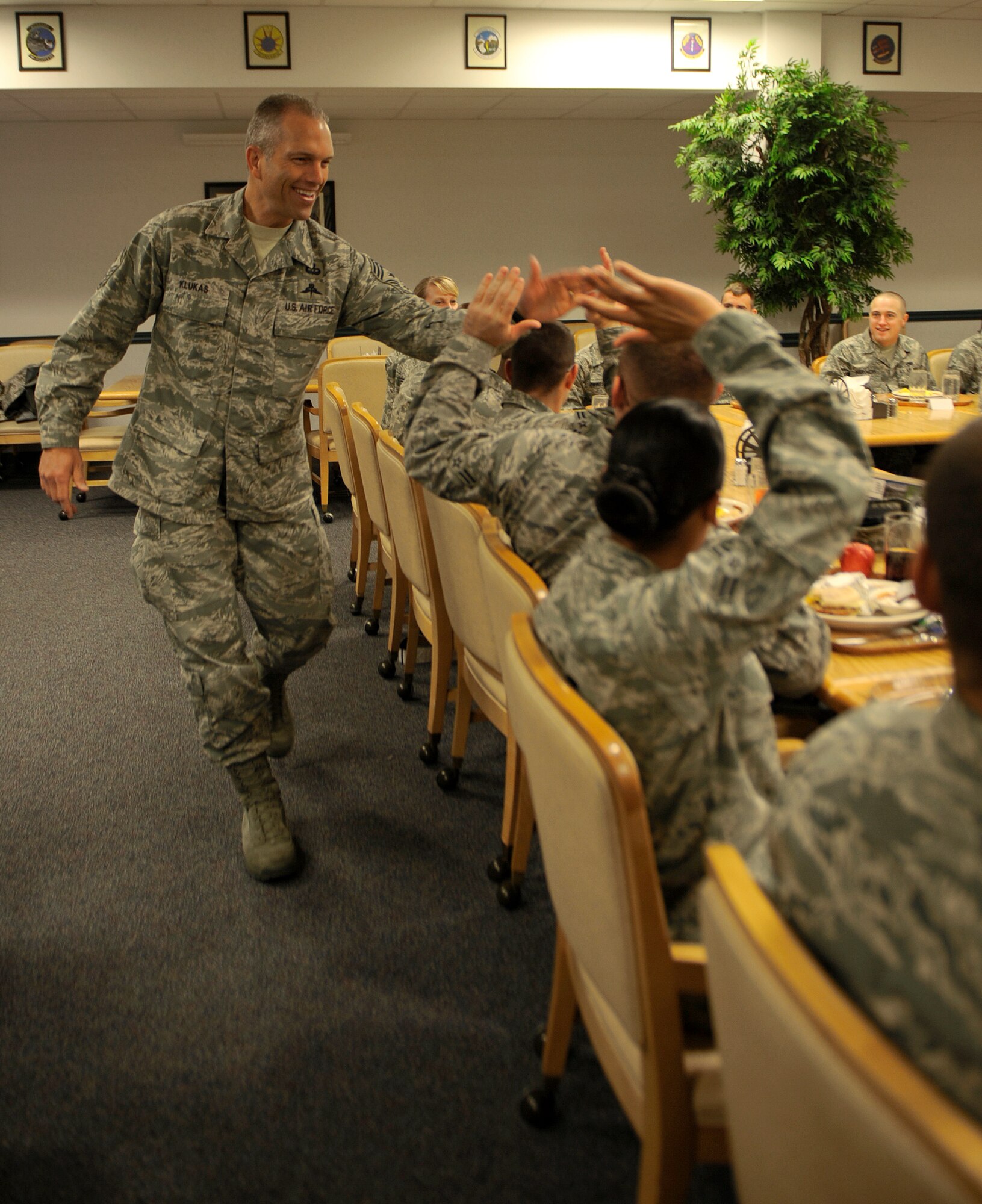 MOUNTAIN HOME AIR FORCE BASE, Idaho -- Chief Master Sgt. Martin Klukas, Air Combat Command command chief, high fives the new graduates of the First Term Airman Center at the Wagon Wheel Oct. 28. Chief Klukas recently spent three days touring the base to learn about the Gunfighters' mission. (U.S. Air Force photo by Senior Airman Renishia Richardson) 