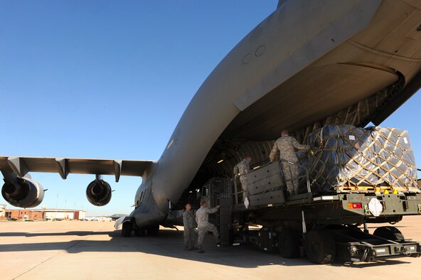 Airmen with the 509th Logistics Readiness Squadron, load humanitarian aid cargo onto a C-17, Oct 17, 2010 to be shipped to people in need in Honduras. (U.S. Air Force photo by Senior Airman Kenny Holston)(Released)