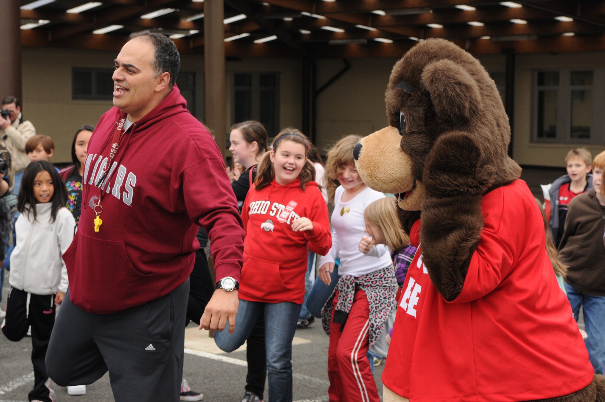 SPANGDAHLEM AIR BASE, Germany – The Drug Free Bear helps Linville Hairstone, Bitburg Middle School Physical Education coach, lead the students in stretching before a one-mile fun run around the middle school block Oct. 28. The Red Ribbon Week fun run helped raise awareness about the dangers of drug and alcohol abuse. (U.S. Air Force photo/Airman 1st Class Matthew B. Fredericks)