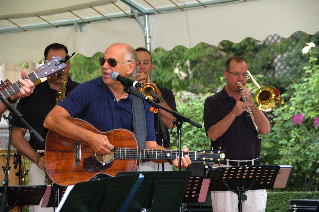 PARIS -- Grammy award winning recording artist Jimmy Buffett (center front) performs members of the U.S. Air Forces in Europe Band "Direct Hit" at the U.S. Embassy-Paris Sept. 23, 2010. Direct Hit provided entertainment support to the embassy for its annual Rentree Barbecue. Mr. Buffett was a guest of honor at the event and also performed some of his hits with the USAFE Band. (U.S. Air Force photo/Staff Sgt. Craig Bowman)