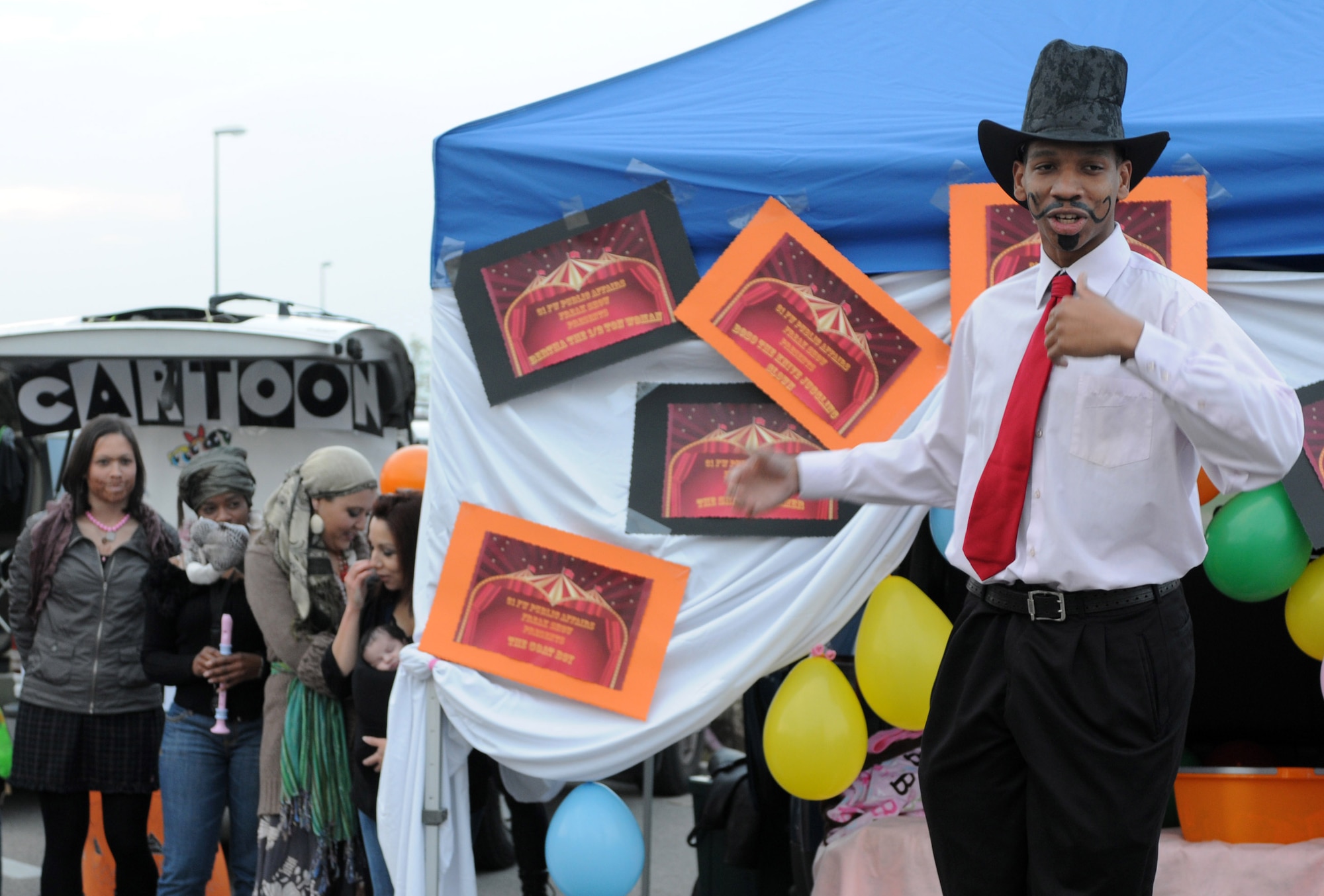 Dressed as a ringmaster, Airman 1st Class LaVel Sterling, 31st Fighter Wing Public Affairs photographer, welcomes visitors to the "Public Affairs Freak Show" during the annual Trunk-or-Treat on Capt. Gori Road Oct. 30. The 31st FW/PA Freak Show received first place for the best trunk contest. (U.S. Air Force photo/Staff Sgt. Julius Delos Reyes)