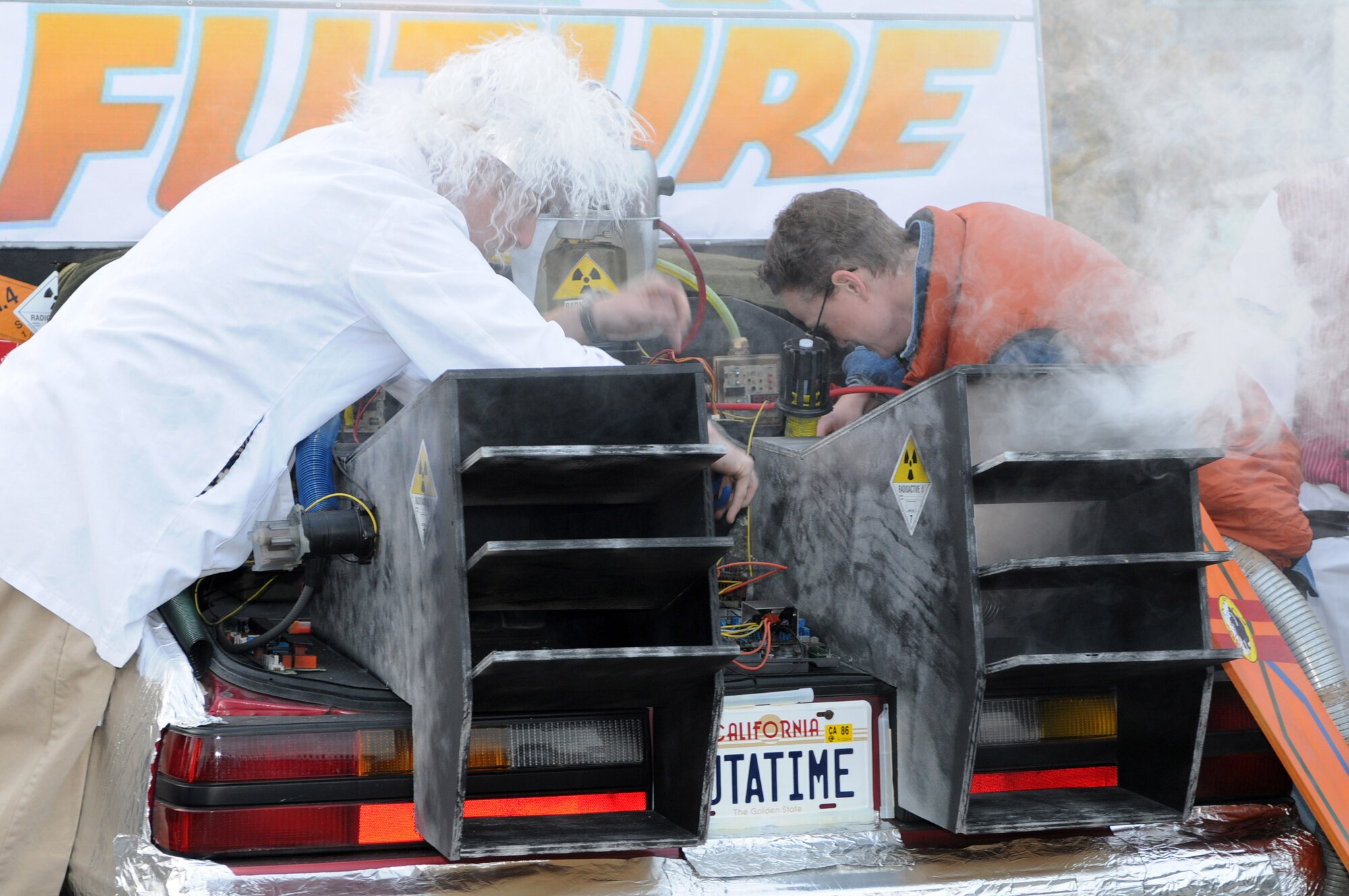 Staff Sgt. Christopher Gapetz (left), 31st Civil Engineer Squadron readiness and emergency management craftsman, and Staff Sgt. Kerstin Pieren, 31st CES structural journeyman, play Back to the Future's "Doc Brown" and "Marty McFly," respectively, during the annual Trunk-or-Treat Oct. 30 on Capt. Gori Road. The 31st CES Emergency Management received second place for the best trunk contest. (U.S. Air Force photo/Staff Sgt. Julius Delos Reyes)