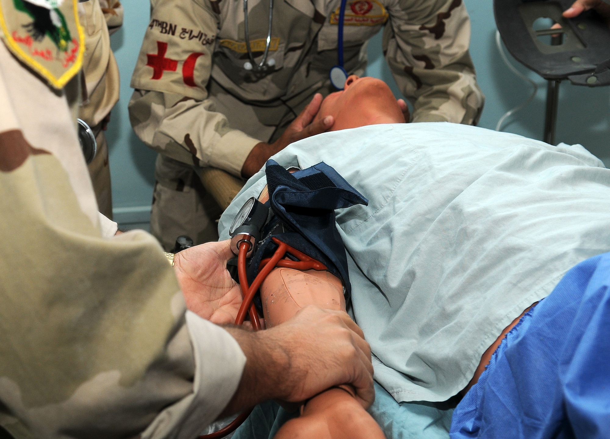 A member of the Iraq Army stabilizes the head of a medical training manikin in the simulation of a possible injury to the neck or back during the In-Country Clinical Observership at Joint Base Balad, Iraq, Oct. 26, 2010. After graduating, trainees will provide hands-on care to Iraqi Security Forces personnel and Iraqi civilians.  (U.S. Air Force photo/Senior Airman Marianne E. Lane)
