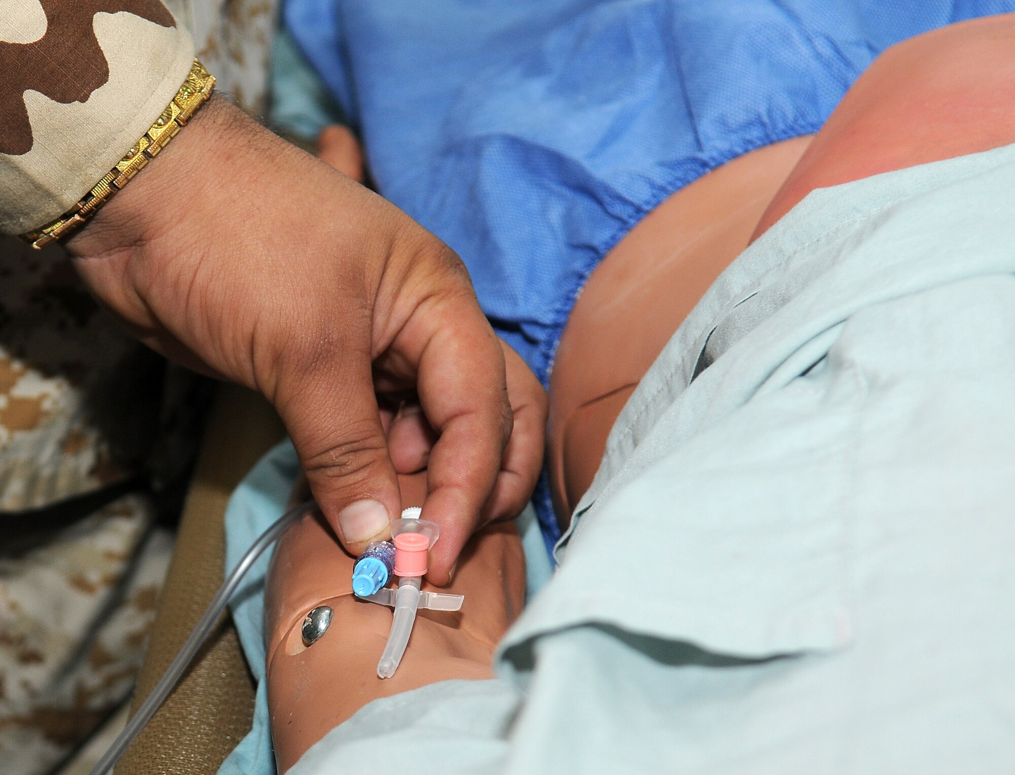 A member of the Iraq Army places an intravenous line where it would normally enter a vein on a medical training manikin during the In-Country Clinical Observership at Joint Base Balad, Iraq, Oct. 26, 2010.  The ICCO provides Iraqi physicians and nurses observation, plus hands-on training experiences of clinic and hospital practices. (U.S. Air Force photo/Senior Airman Marianne E. Lane)