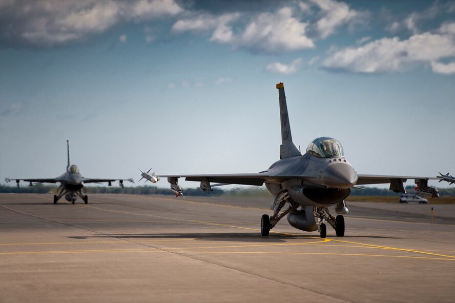 U.S. Air Force Capt. Chris Nations, 14th Fighter Squadron standardization and evaluations officer, and Staff Sgt. Bernard Mutz, 35th Civil Engineer Squadron readiness and emergency manager, taxi to a hardened aircraft shelter in an F-16 Fighting Falcon following an incentive flight at Misawa Air Base, Japan, Oct. 22, 2010. Sergeant Mutz said the flight gave him a new understanding and respect for what pilots do. The 35th Fighter Wing gives incentive flights to outstanding Airmen each year to reward their exceptional work and dedication. (U.S. Air Force photo by Staff Sgt. Samuel Morse/Released)