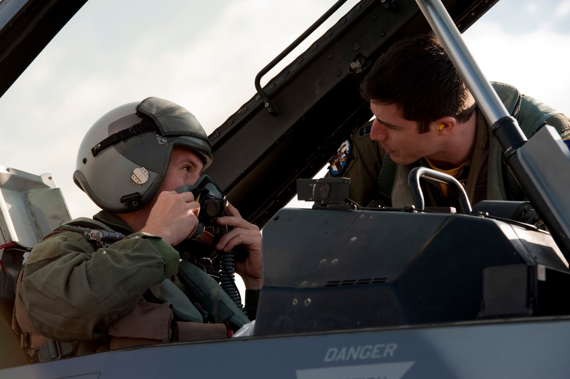 U.S. Air Force Capt. Chris Nations, 14th Fighter Squadron standardization and evaluations officer, reviews the parts of the F-16 Fighting Falcon controls and equipment with Staff Sgt. Bernard Mutz, 35th Civil Engineer Squadron readiness and emergency manager, before takeoff at Misawa Air Base, Japan, Oct. 22, 2010. Pilots keep safety at the forefront of their priorities, making sure incentive flight riders understand emergency proceedures in the unlikely event of an in-flight emergency. The 35th Fighter Wing gives incentive flights to outstanding Airmen each year to reward their exceptional work and dedication. (U.S. Air Force photo by Staff Sgt. Samuel Morse/Released)