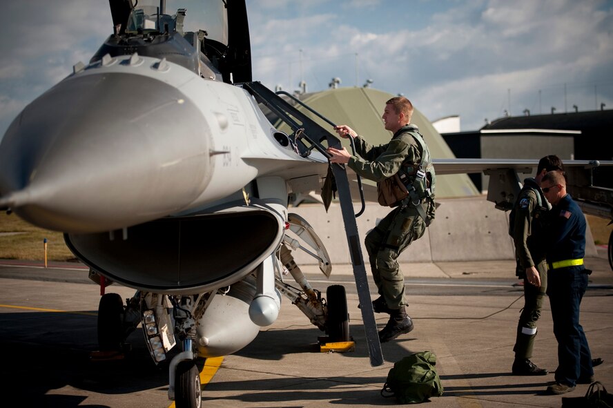 U.S. Air Force Staff Sgt. Bernard Mutz, 35th Civil Engineer Squadron readiness and emergency manager, climbs into the back seat of an F-16 Fighting Falcon at Misawa Air Base, Japan, Oct. 22, 2010. Sergeant Mutz said he couldn't sleep the night before due to his excitement. The 35th Fighter Wing gives incentive flights to outstanding Airmen each year to reward their exceptional work and dedication. (U.S. Air Force photo by Staff Sgt. Samuel Morse/Released)